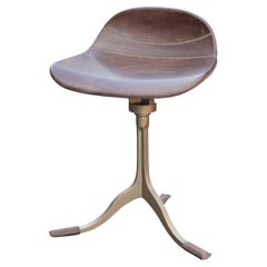 Special height stool with swivel in sand cast brass base and leather seating 