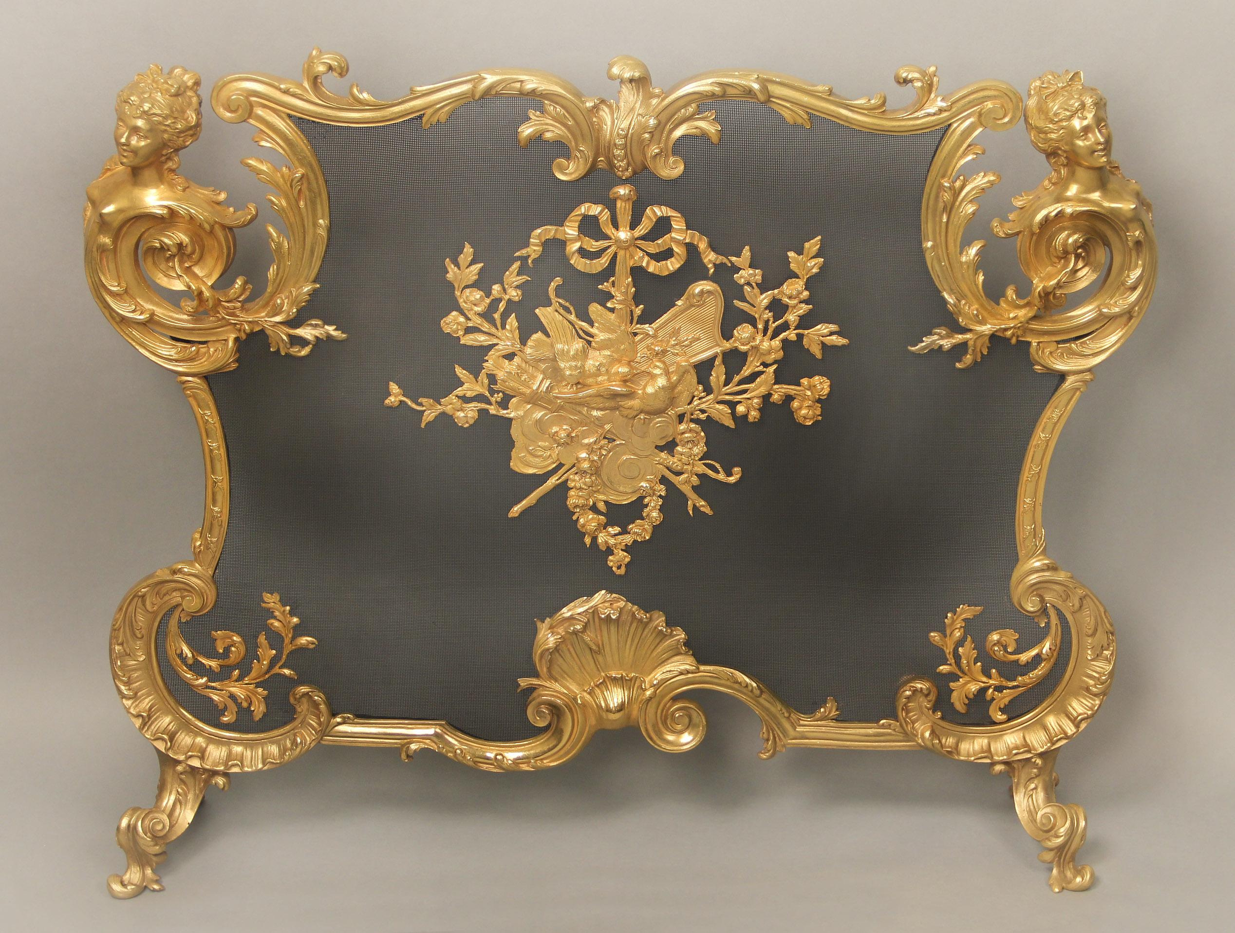 An unbelievable and special late 19th century gilt bronze firescreen by Maison Bouhon Frères for François Linke

Bouhon Frères for François Linke.

The cartouche-shaped frame cornered by espagnolettes and centered by two love doves perched on