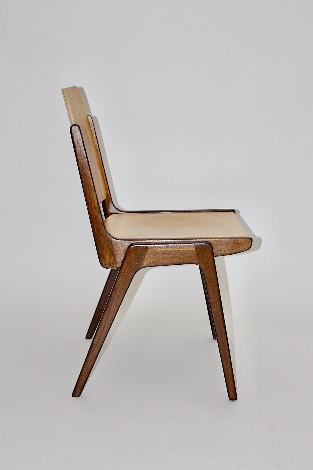 A beechwood bicolor brown Mid-Century Modern vintage set of 10 dining chairs / chairs designed by Franz Schuster 1959, which were executed by Wiesner Hager Austria.
The dining chairs or chairs show the practical feature to stack them if necessary.