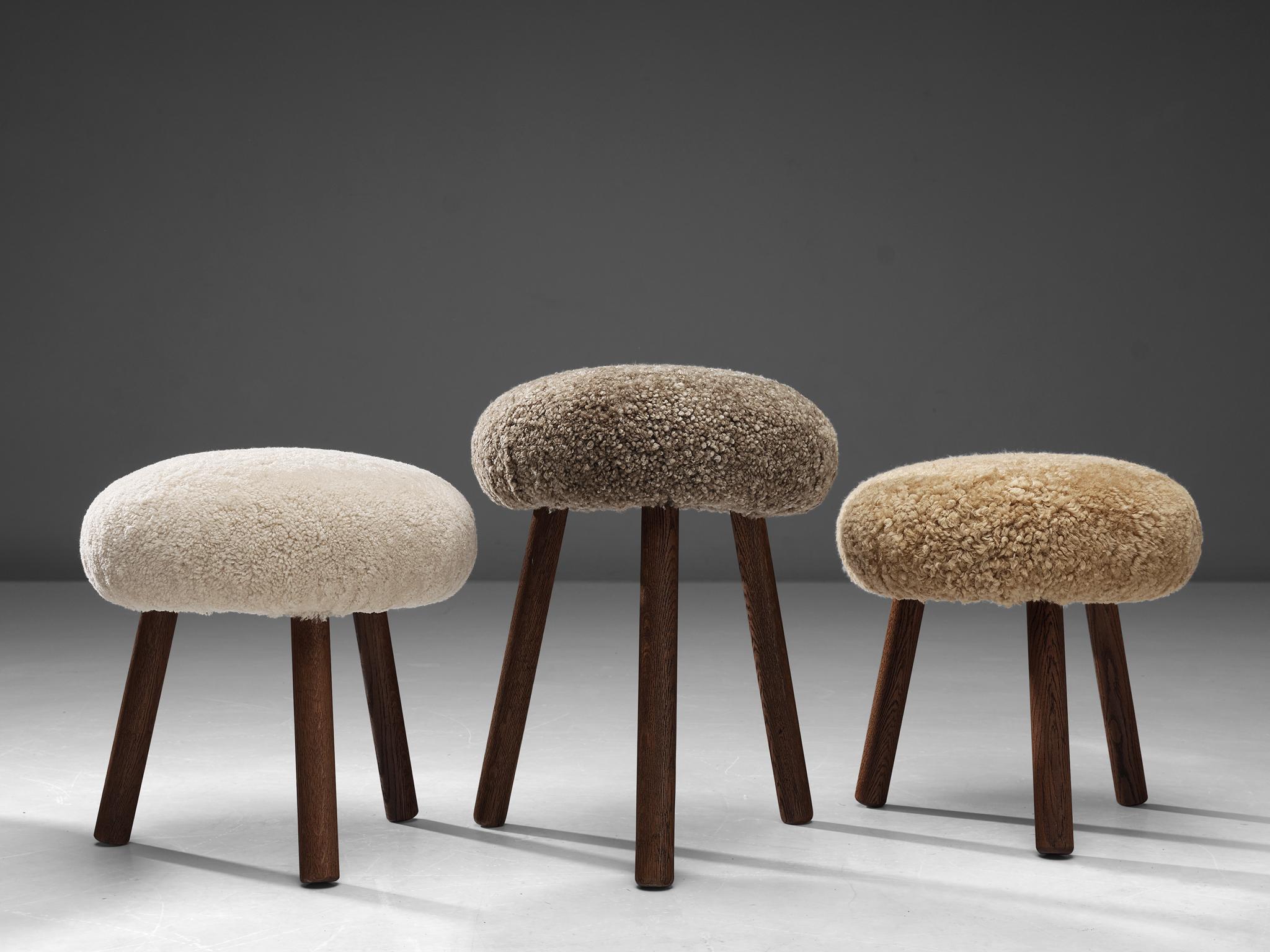Tripod stools or side tables, solid oak, fabric, Switzerland, 1960s-1970s.

Beautiful crafted oak stools originating from the exhibition centre in St. Gallen, Switzerland. The seats are reupholstered in a soft shearling fabric that ranges in colour