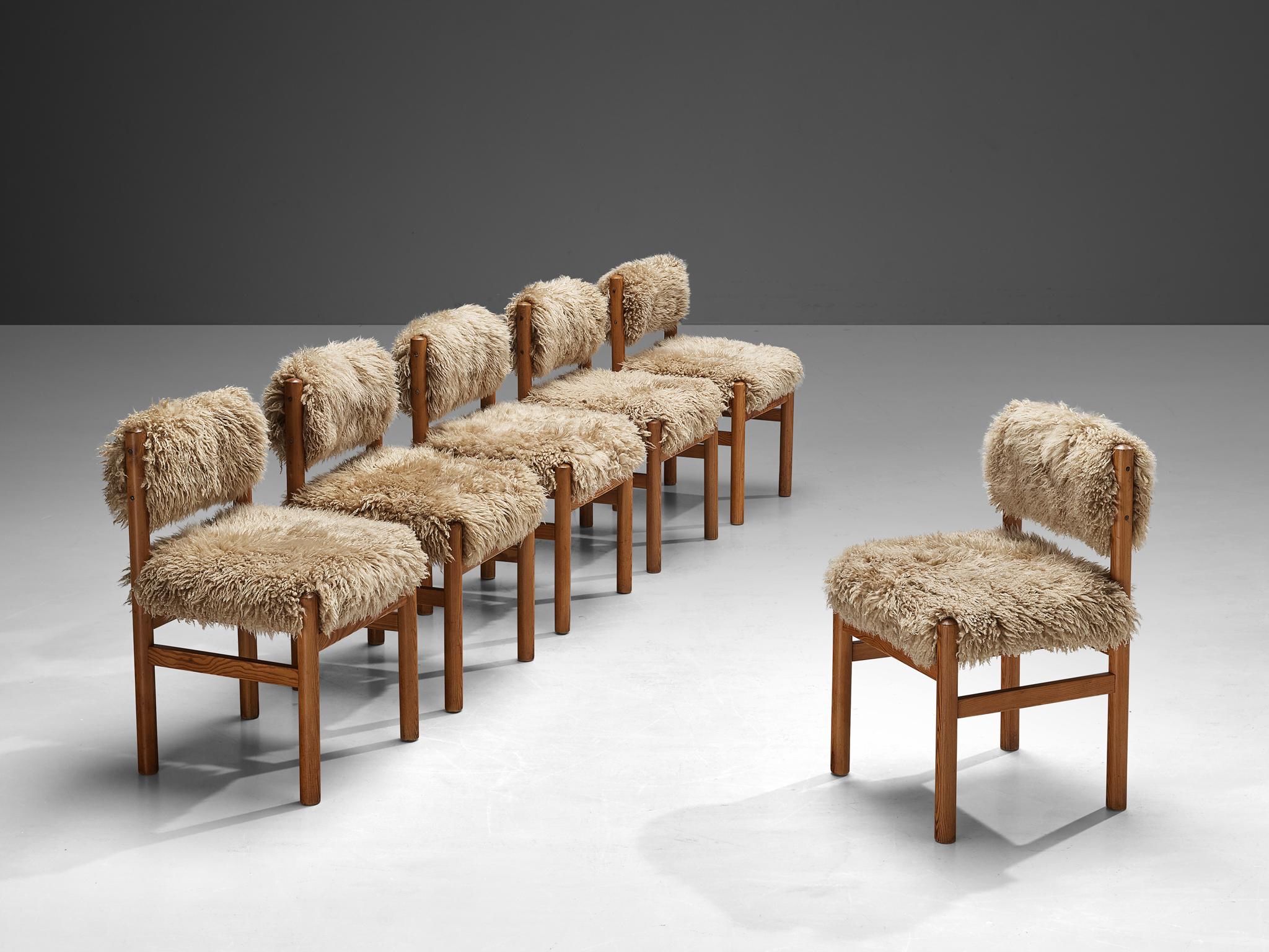 Set of 8 Pine dining chairs by TON featuring a sheepskin in beige color. This particular model is manufactured without armrests. The elegant designed open shape of the frame in combination with the plush and woolly upholstery makes this chair very
