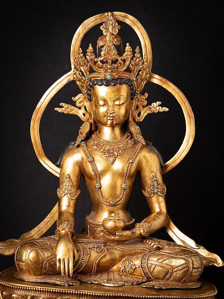 Material: bronze
Measures: 61,5 cm high 
47 cm wide and 35,5 cm deep
Weight: 22.2 kgs
Fire gilded with 24 krt. gold
Bhumisparsha mudra
Originating from Nepal
Middle 20th century
Inlayed with gem stones
Very high quality !
  