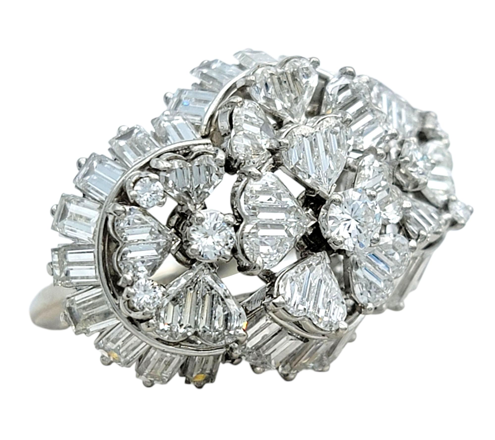 Ring Size: 7.25

This dazzling ring showcases a brilliant arrangement of diamonds in a bold cluster design. A striking combination of specialty cut heart, baguette, and round diamonds creates a dynamic, multi-dimensional look. The high-polished