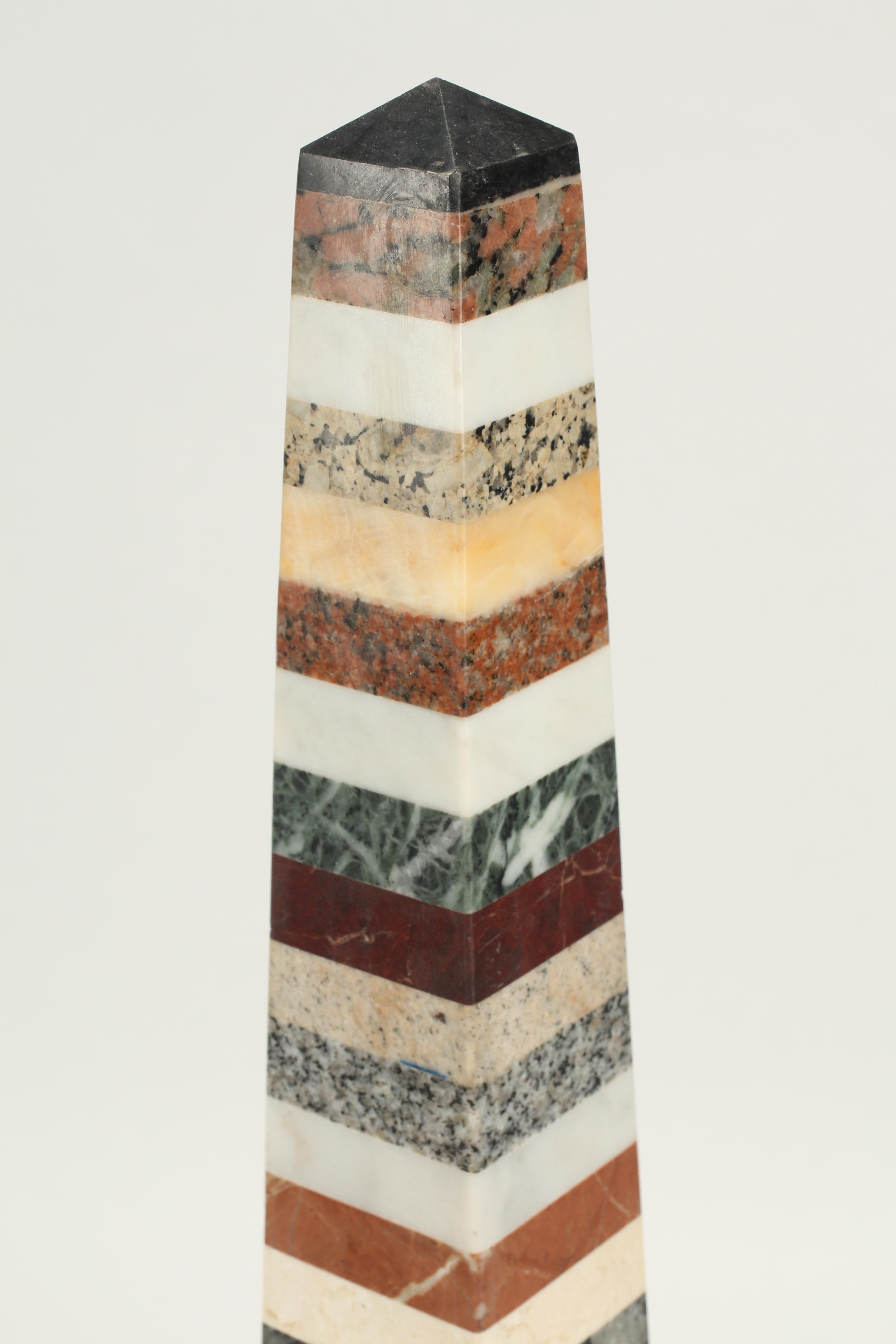 A superb pair of specimen marble obelisks constructed from a variety of specimen marbles. The highly decorative and large scale pair complements traditional and contemporary interiors.