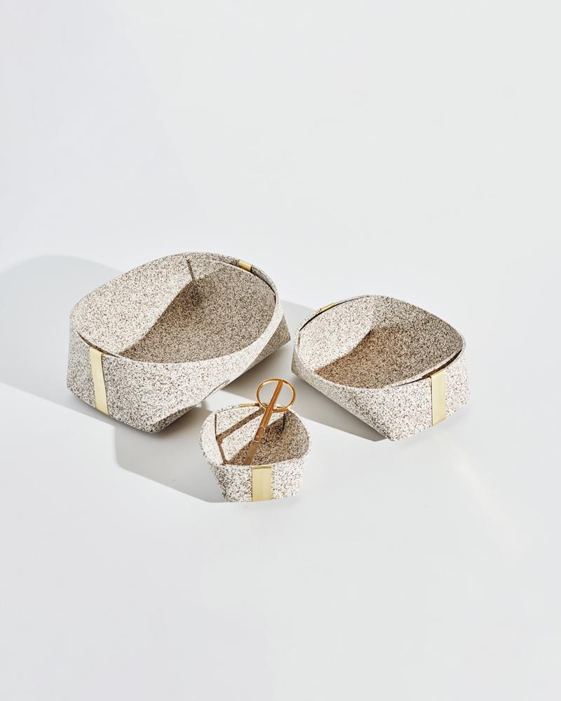Recycled rubber catchalls with brass detailing, perfect for odds and ends around the house. The baskets come in three sizes: small, medium and large. All three baskets nest into one another. 

These baskets are designed with zero-waste. An