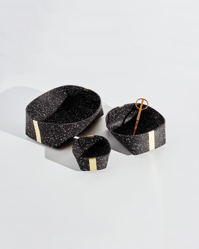 Recycled rubber catchalls with brass detailing, perfect for odds and ends around the house. The baskets come in three sizes: small, medium and large. All three baskets nest into one another. 

These baskets are designed with zero-waste. An