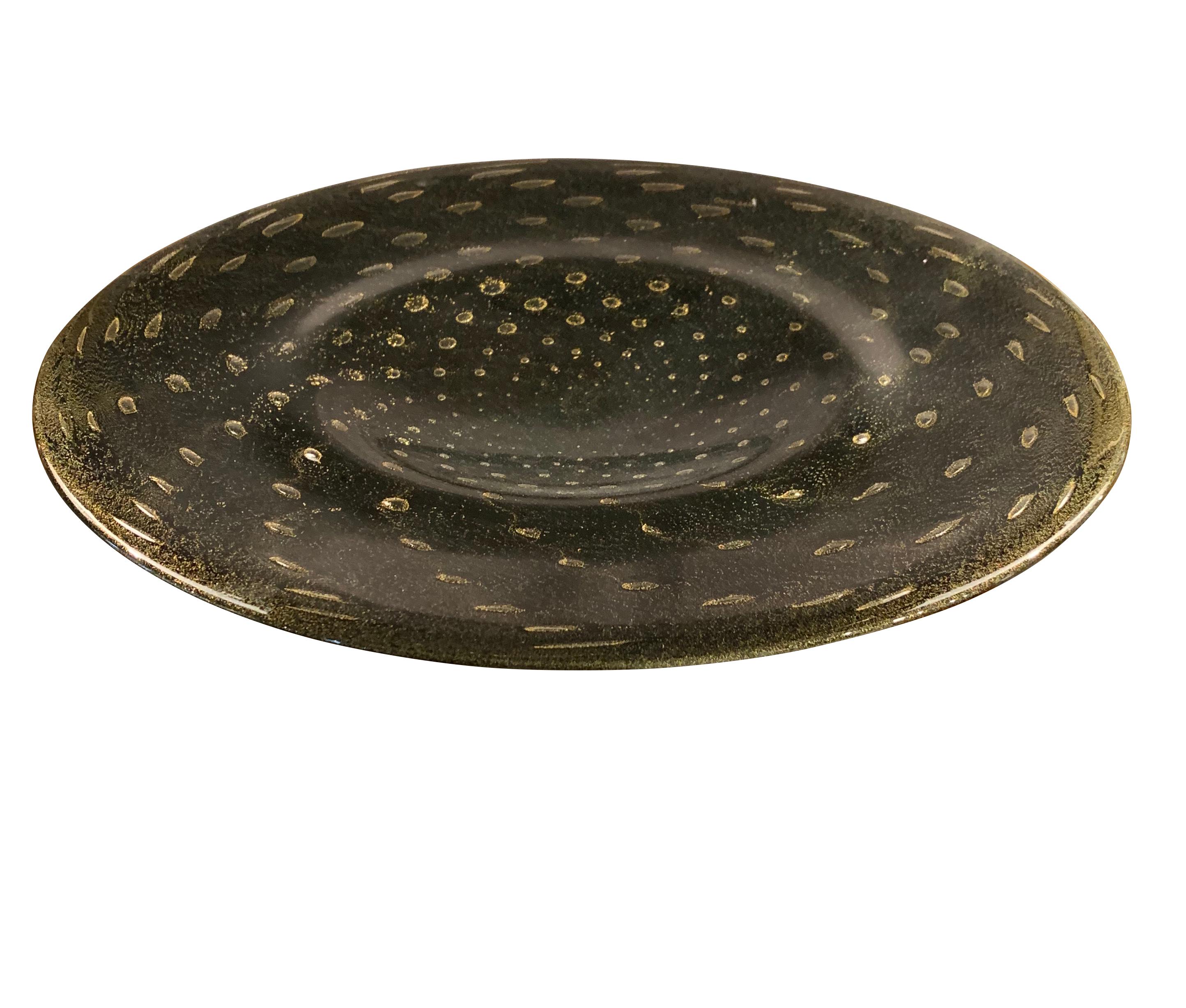 Brazilian handcrafted round thick glass platter with swirling speckled 24-karat gold / black pattern.
 