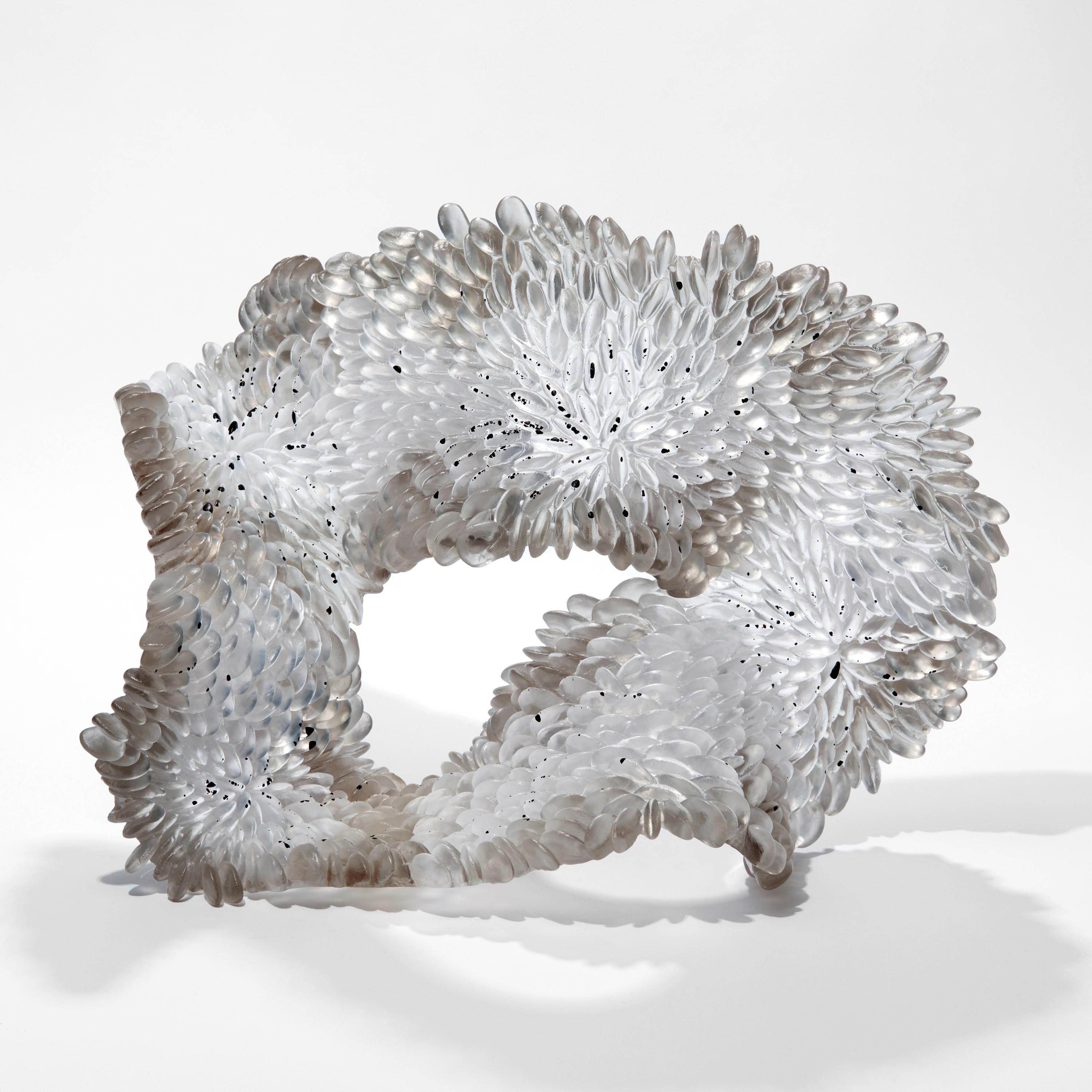 'Speckled Grey' is a unique glass sculpture by the British artist, Nina Casson McGarva.

Casson McGarva firstly casts her glass in a flat mould where she introduces all of the beautifully detailed, scaled surface texture, all unique and to her