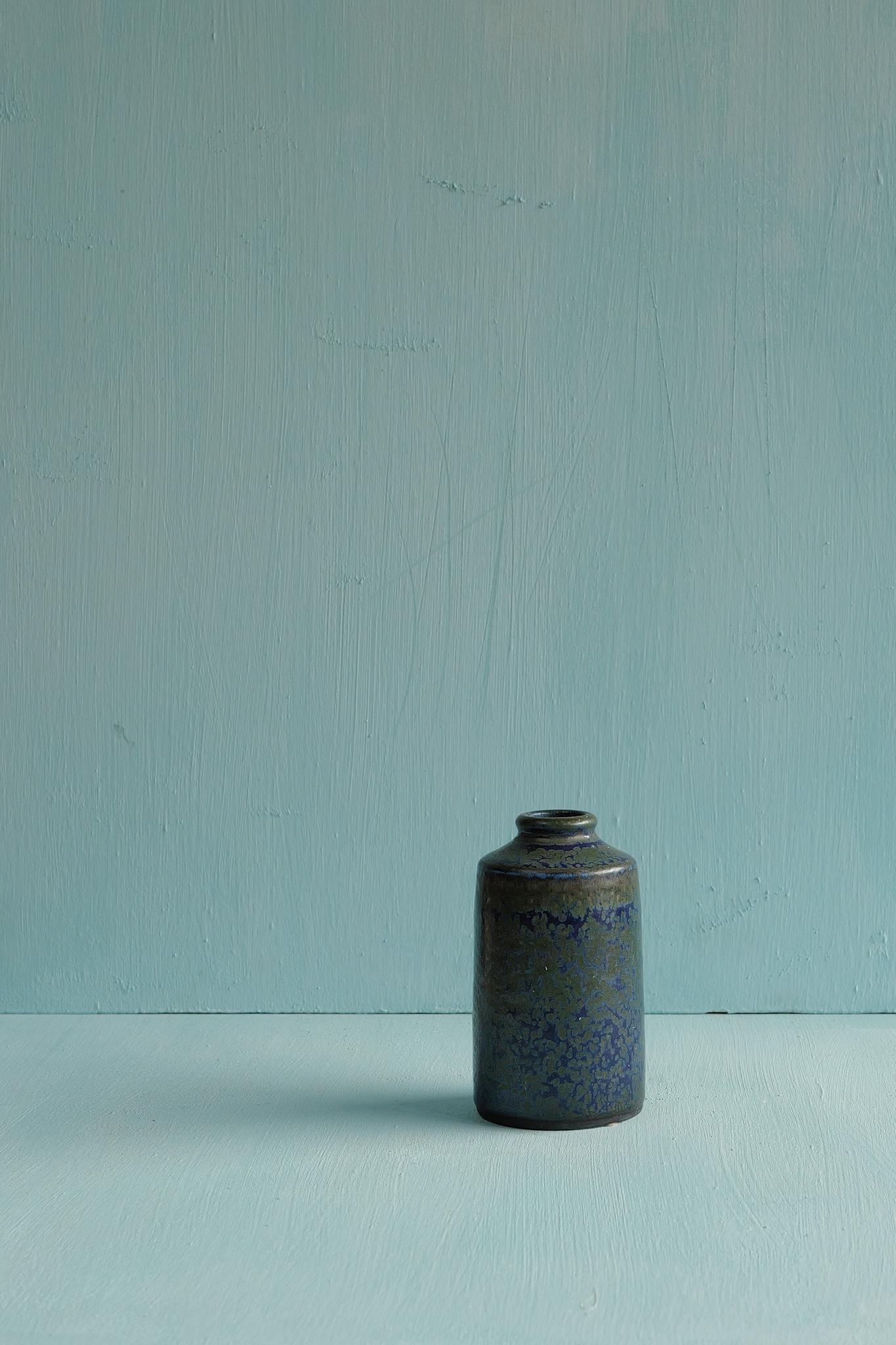A small dark blue speckled stoneware vase designed by Carl-Harry Stålhane and produced by Rörstrand, Sweden, 1960s.

Carl-Harry Stålhane joined Rörstrand in 1939, beginning as a decorator under Gunnar Nylund before becoming one of Sweden’s most