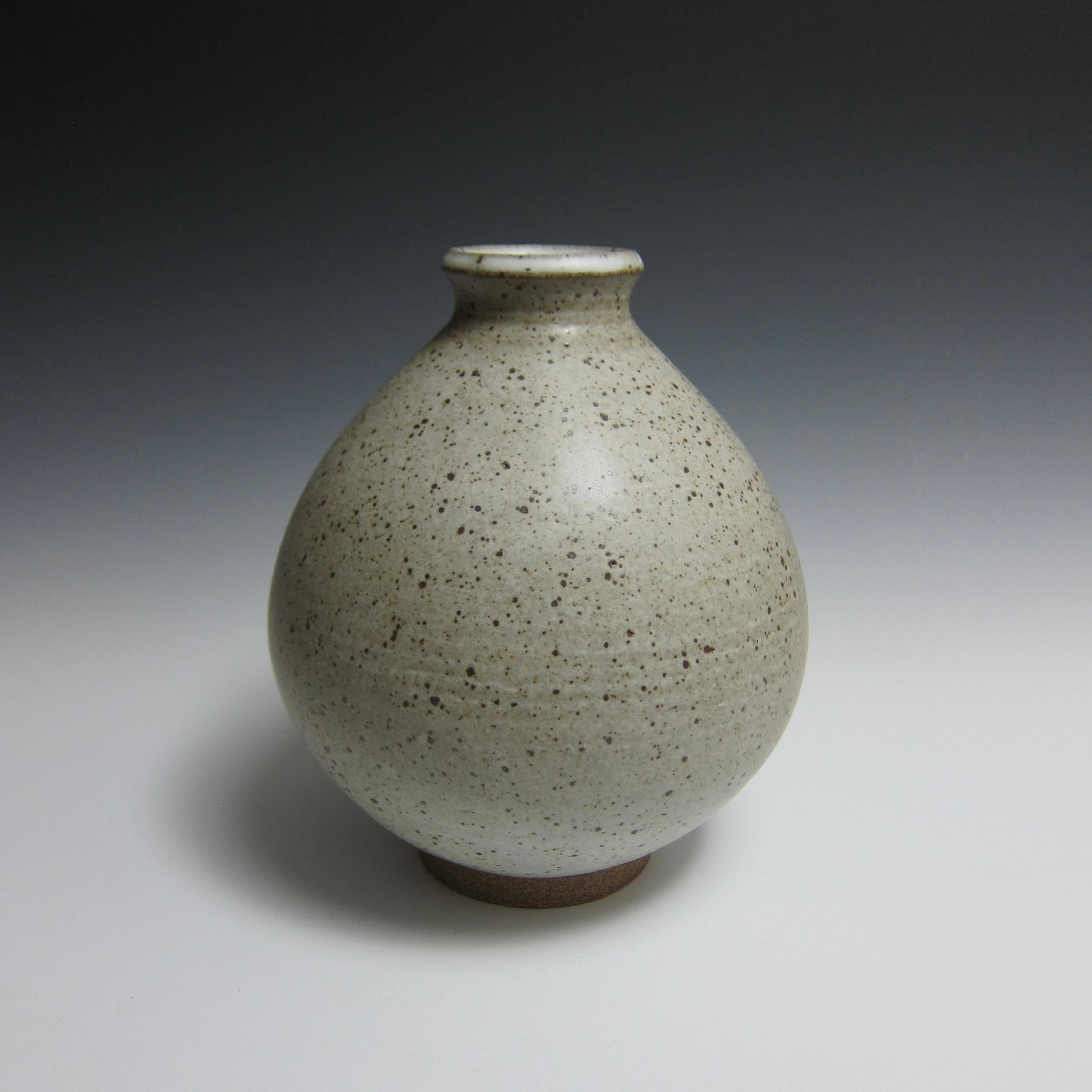 Wheel Thrown Speckled White Flower Bottle by Jason Fox

A Southern Californian for over half his life, Contemporary Ceramic Artist Jason Fox draws upon his classical education in Architecture and Art History as well as his love of surfing and the