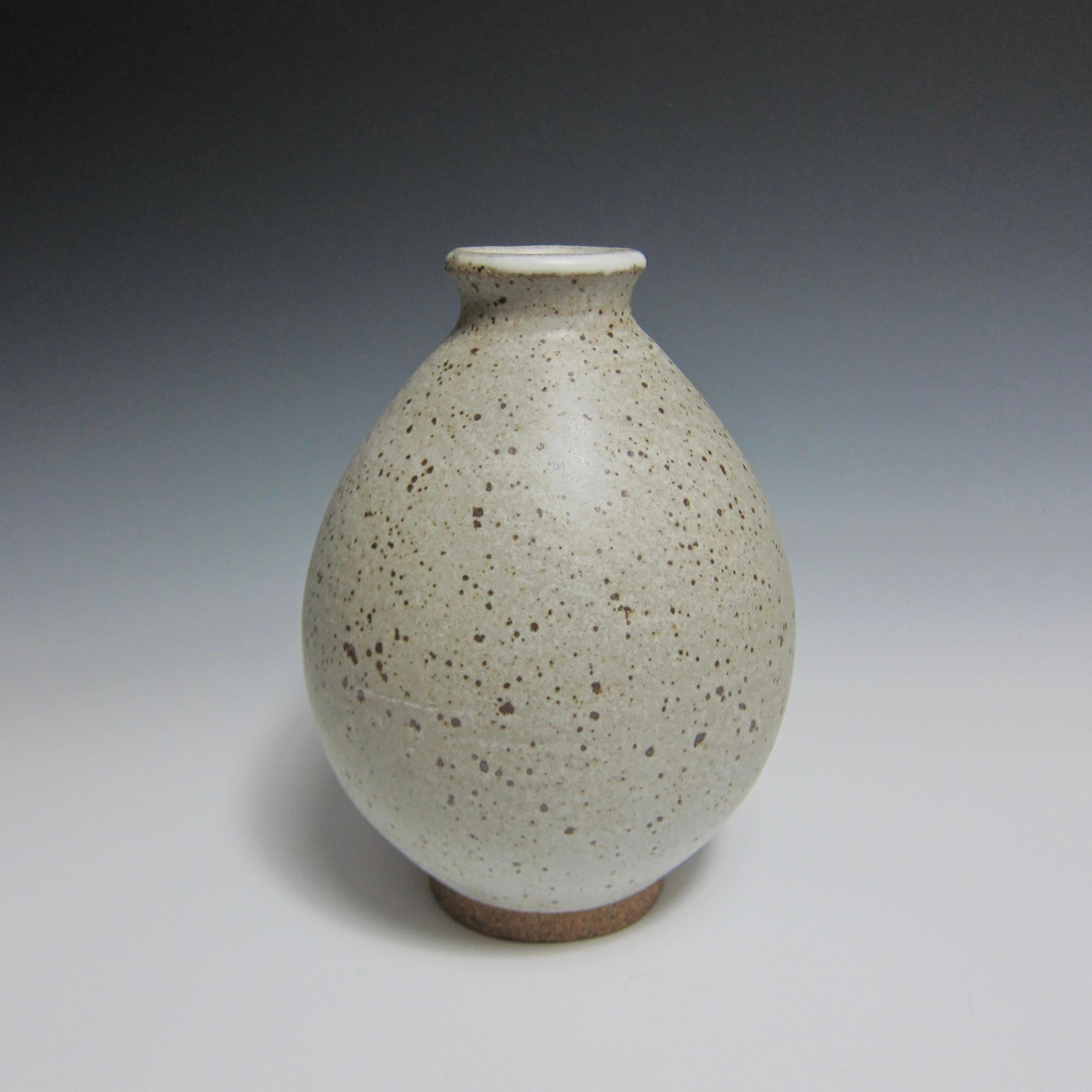 Wheel Thrown Speckled White Flower Bottle by Jason Fox.

A Southern Californian for over half his life, Contemporary Ceramic Artist Jason Fox draws upon his classical education in Architecture and Art History as well as his love of surfing and the