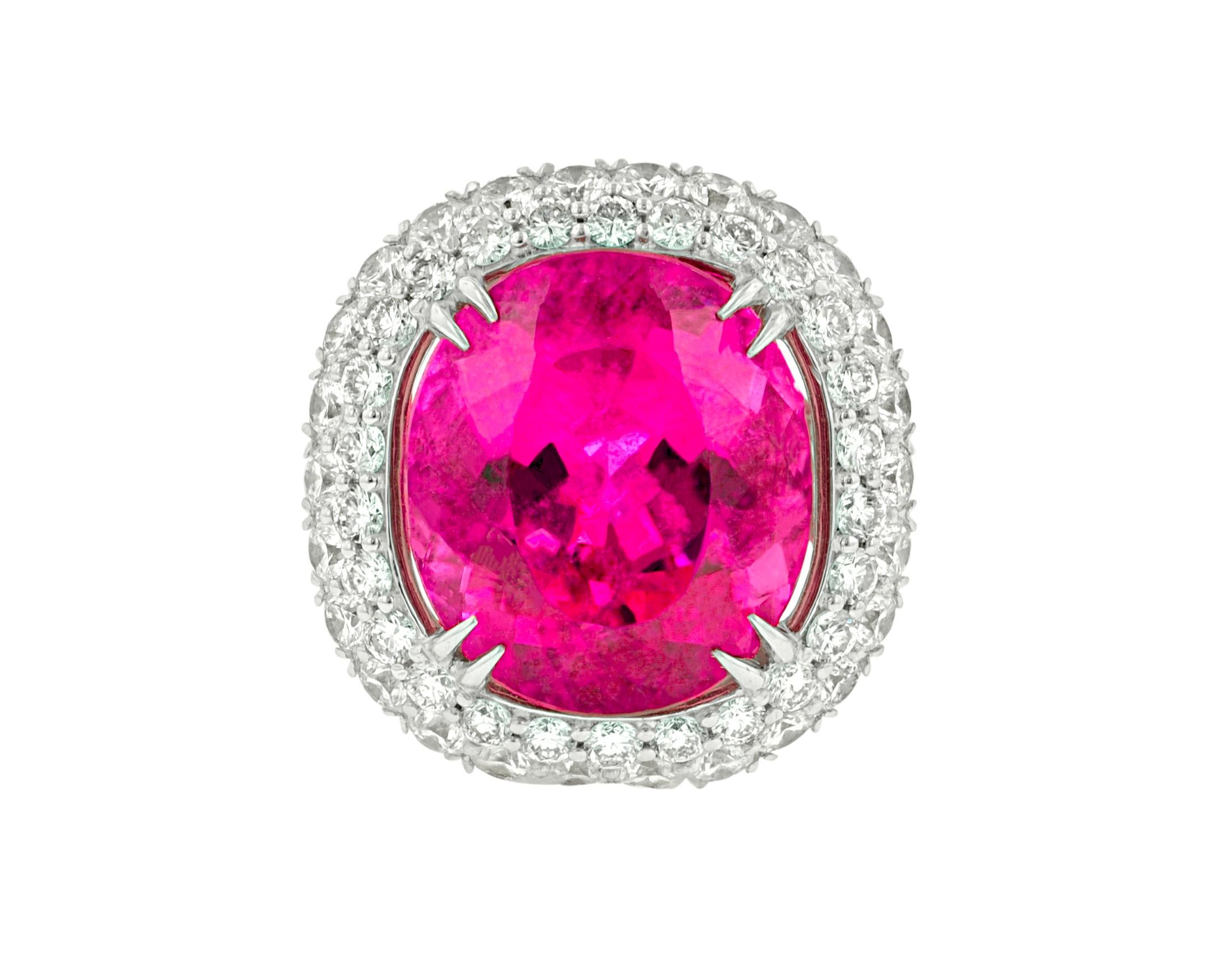 This 18 KT. white gold Intense Tourmaline and Diamond Ring, features 14.87 CT. intense color tourmaline in the center, surrounded by 4 carats of fine color and clarity round brilliant cut diamonds. This is a hand made ring, it was designed by Diana