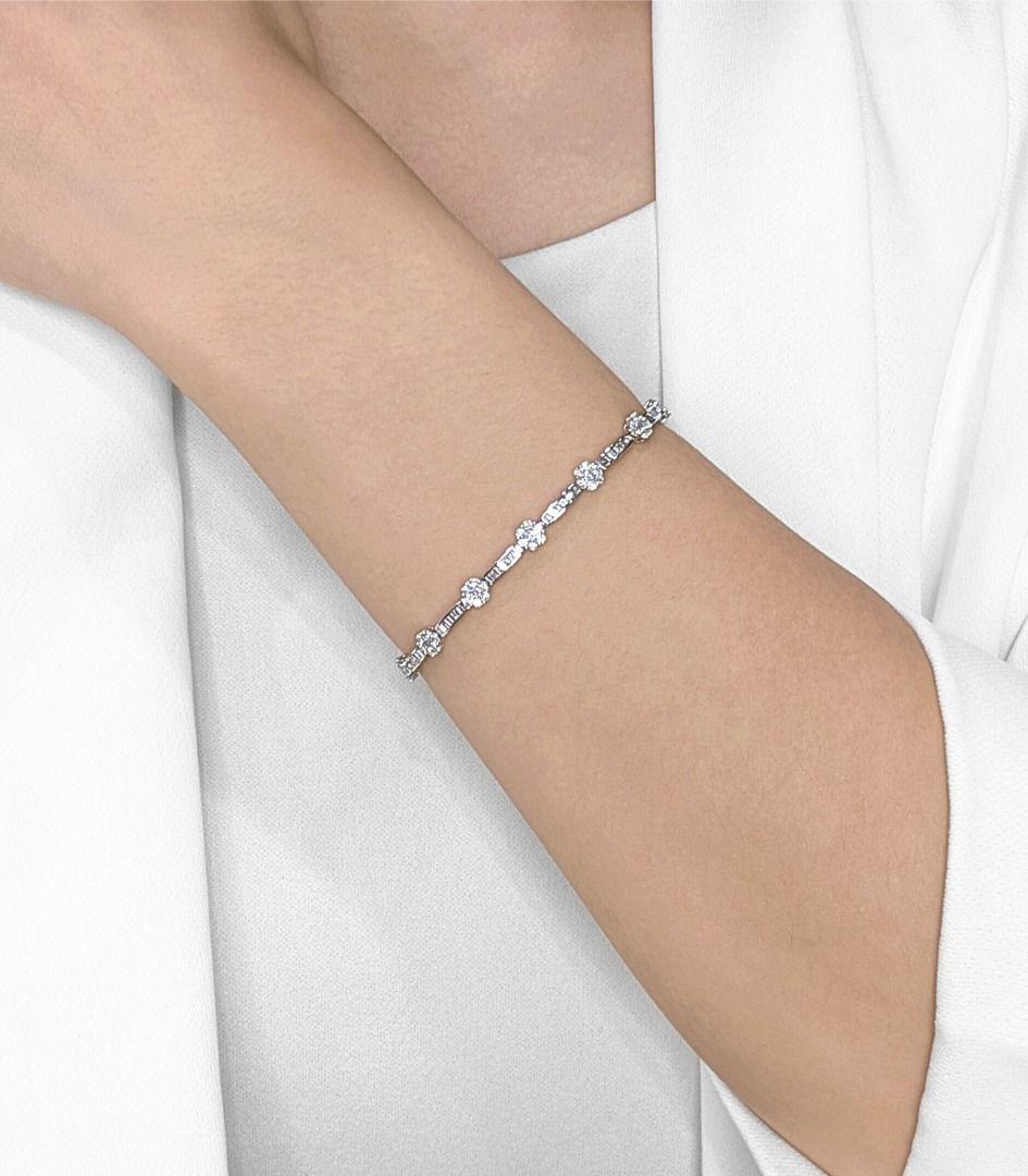 Adorn your wrist with the breathtaking brilliance of this spectacular 18K white gold bracelet, a masterpiece of intricate design and dazzling sparkle. A remarkable total of 91 natural round brilliant diamonds, weighing a brilliant 0.91ct, create a
