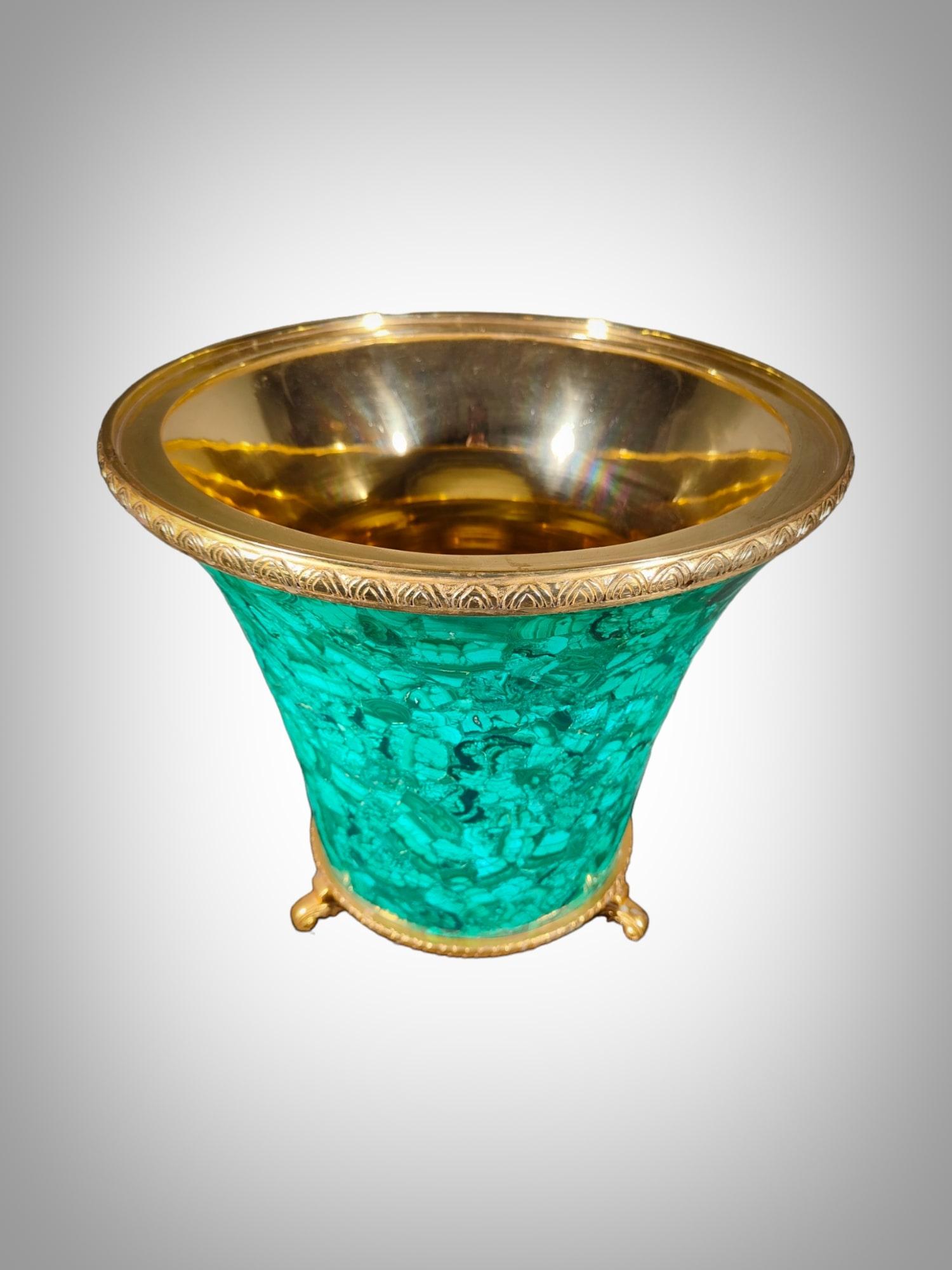 This spectacular 1950s Italian wine cooler, crafted in malachite, is a testament to the exquisite craftsmanship of the era. The combination of the dazzling green malachite and the golden brass interior adds a touch of opulence to this piece. This