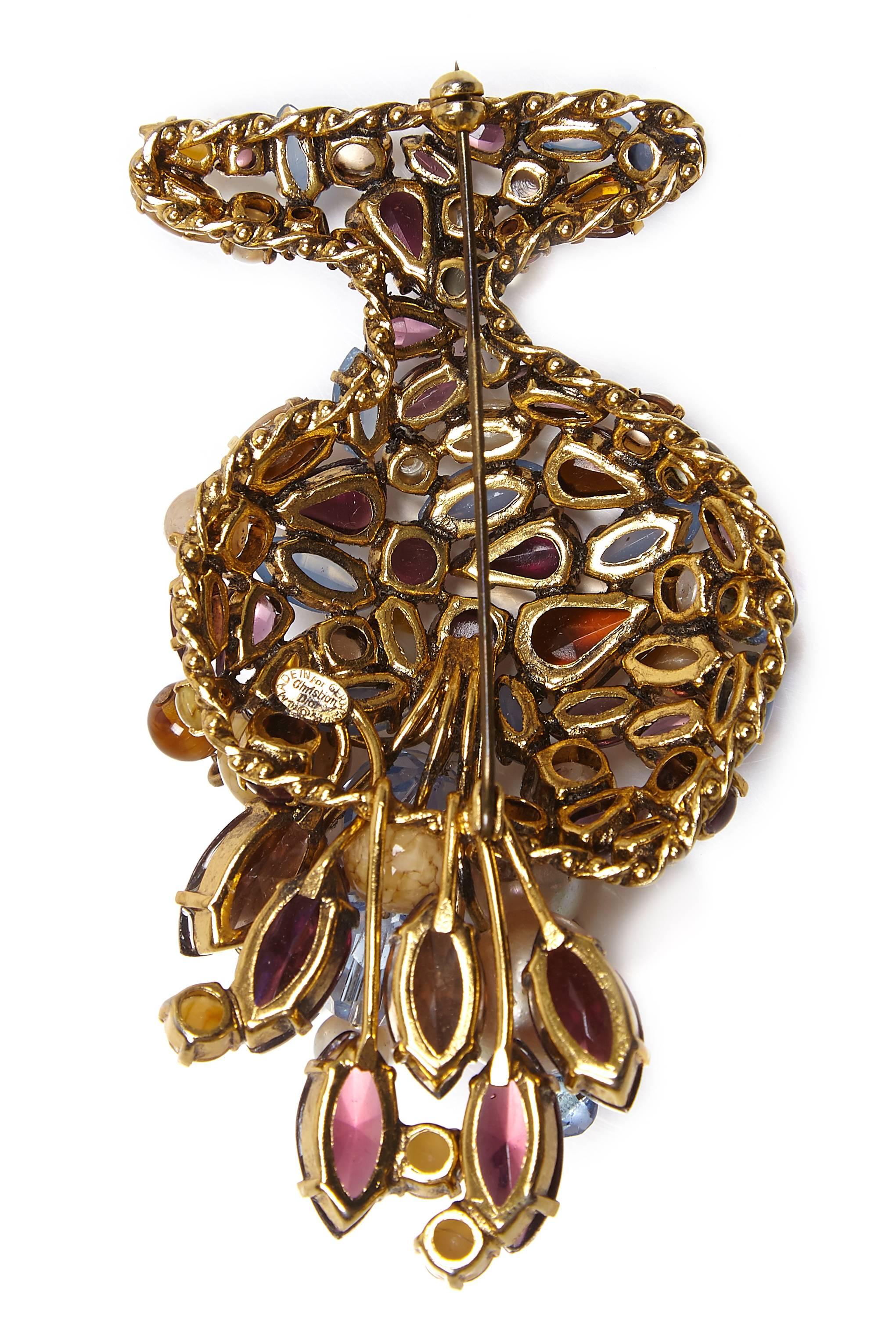 Spectacular 1960s Christian Dior brooch designed by Henkel & Grosse circa 1960.  Abstract design so can be worn a number of variations with prong-set glass stones in deep amber, purple and blue; set with several glass pearls and in gold coloured