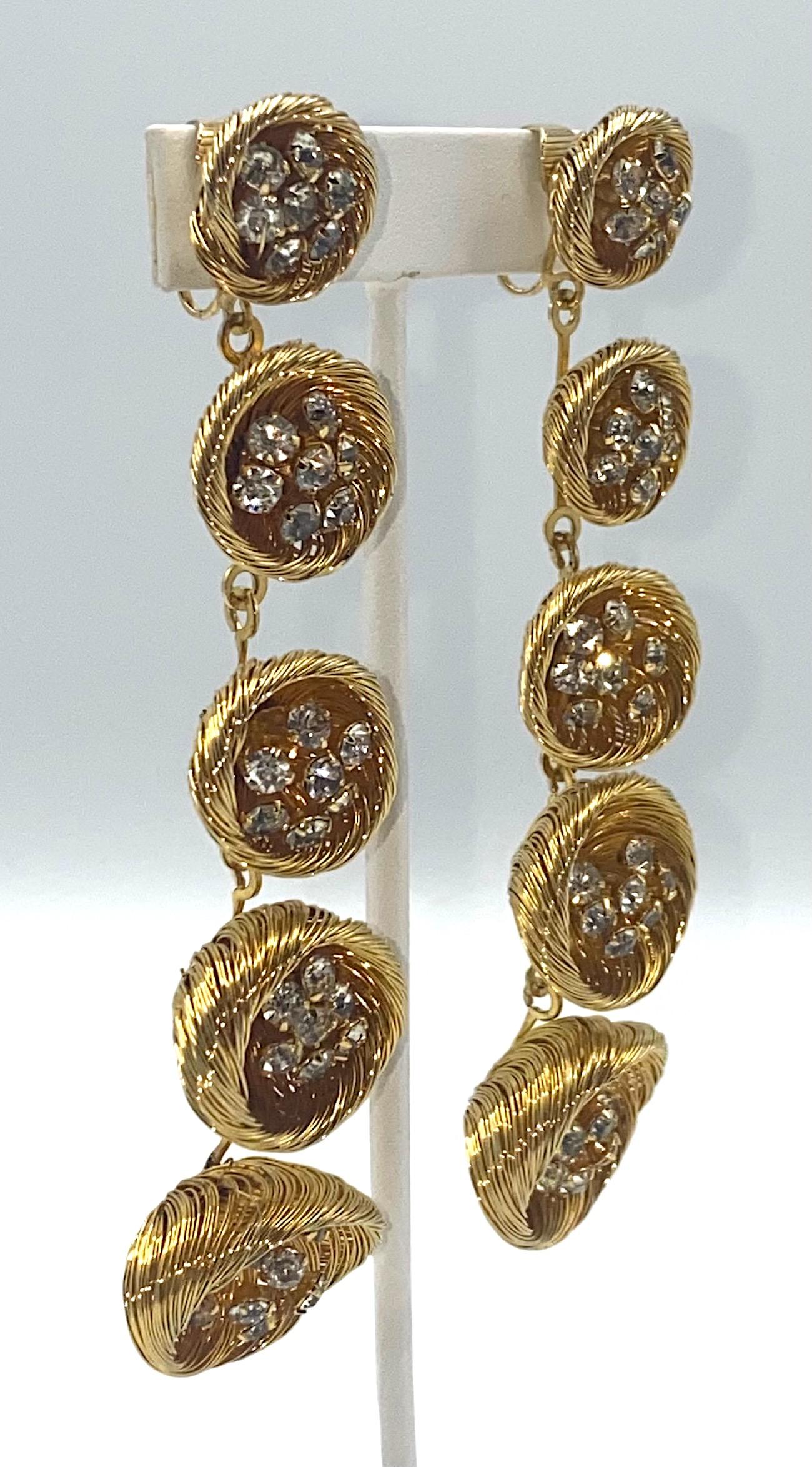 A stunning and unique pair of lat 1950s to mid 1960s hand made long Mod pendant earrings. Each pair is comprised of five hand woven gold tone wire cups graduating from smaller to larger from top to bottom. Each woven cup has little clusters of wire