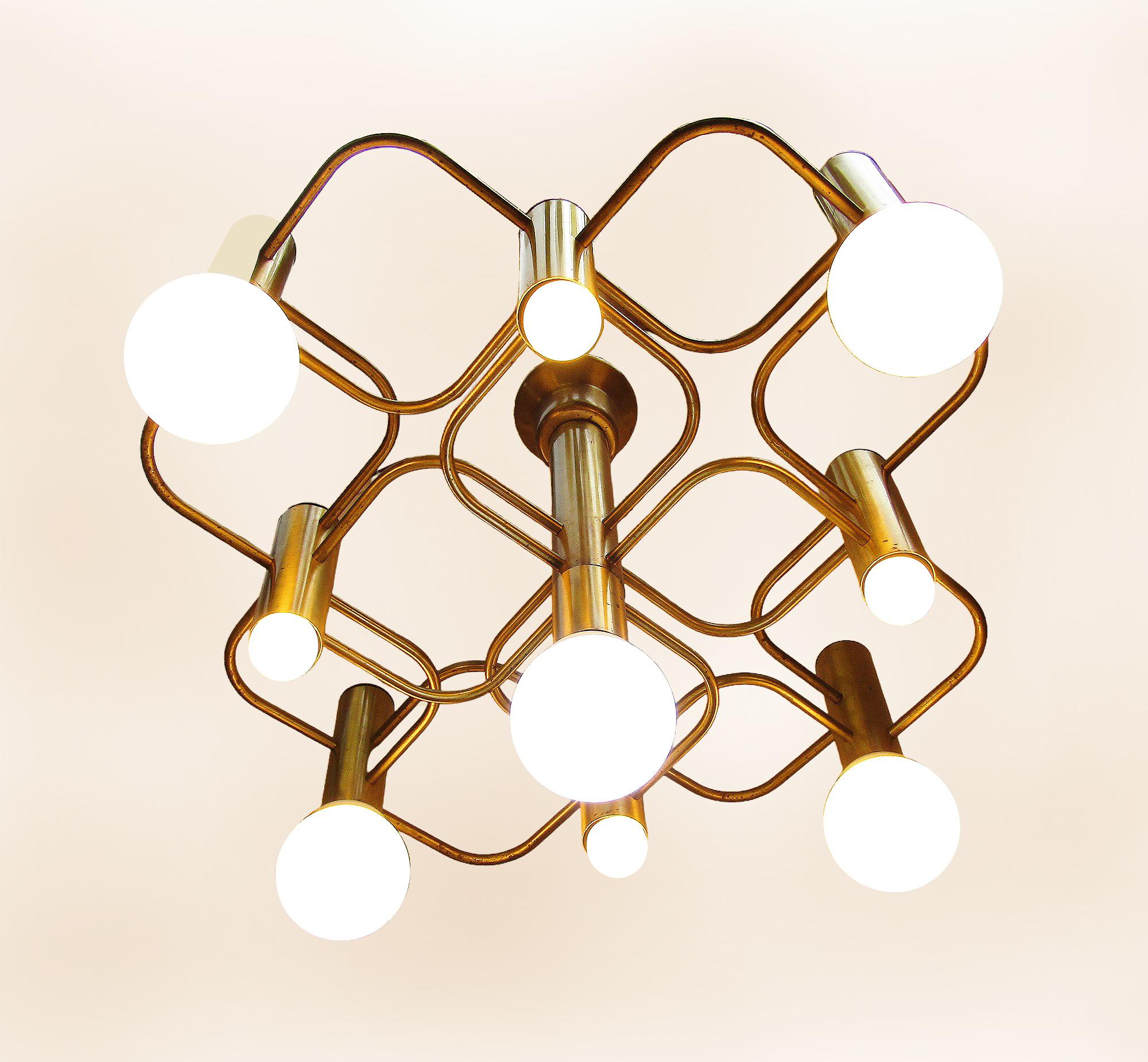 A spectacular original 1960s modernist chandelier in brass by Gaetano Sciolari.

It has nine individual lights. Each bulb holder allows for large, decorative bulbs. A combination of sizes can also be used, to stellar effect. It is photographed with