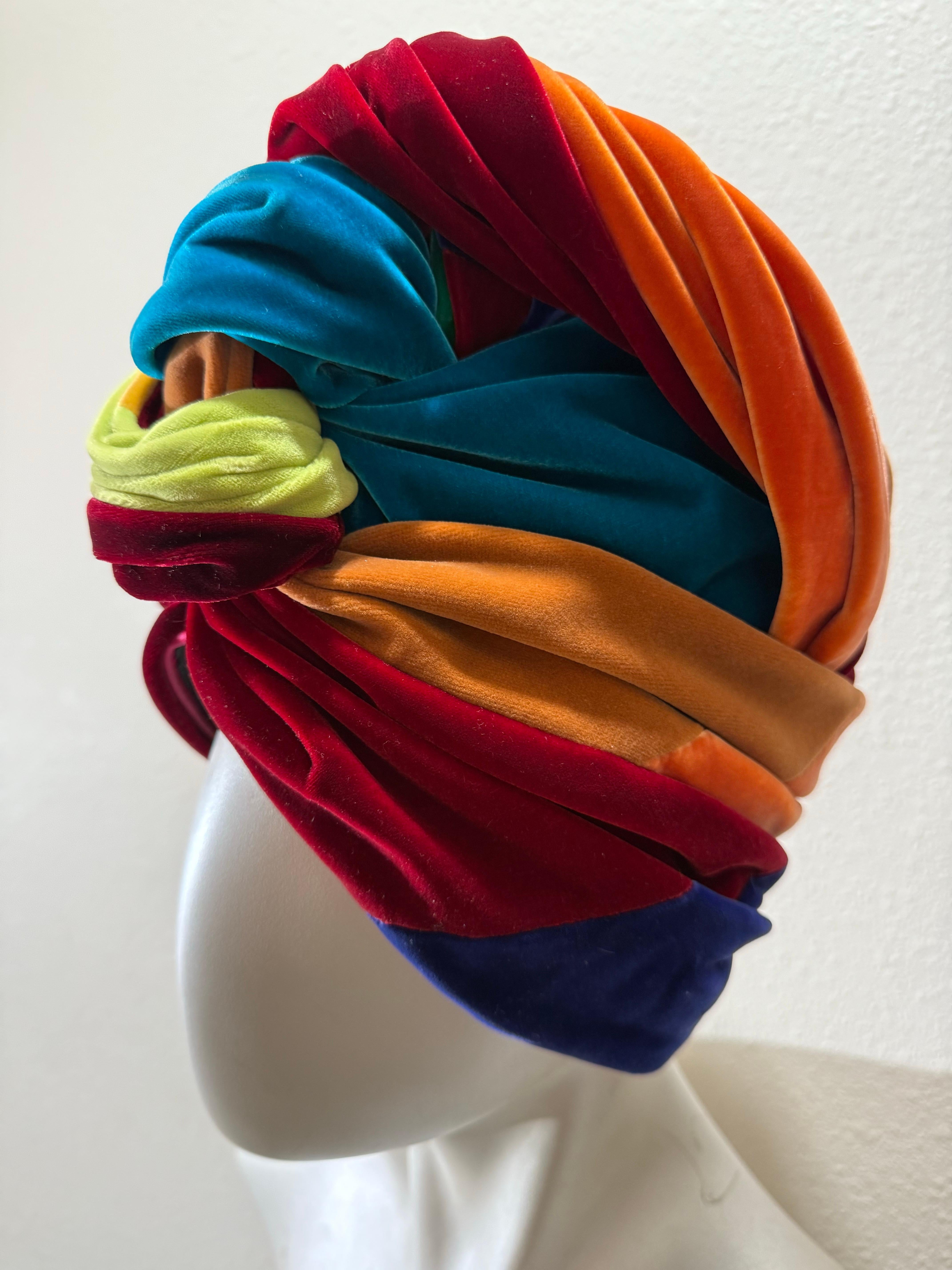 Spektakuläre 1960er Lilly Dache Multicolor Seide Samt High-Rise geknotet Turban:  Dieser neue, nie getragene und mit Anhängern versehene Turban eines legendären Hutmachers ist ein echter Hingucker! In einer üppigen Palette von Farben ist die Form