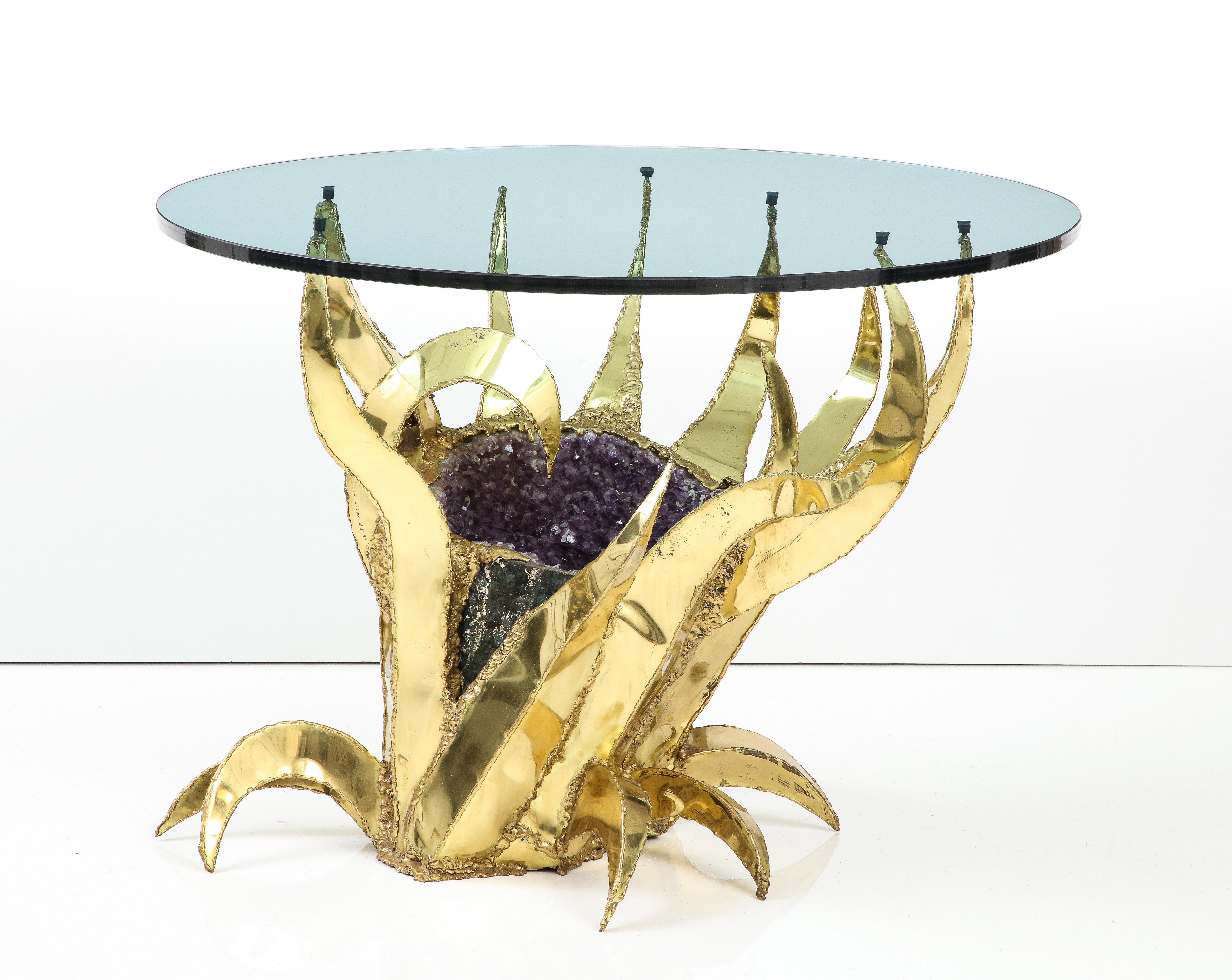 Spectacular 1970's Amethyst Geode table.
The brass Brutalist base is formed around a large Amethyst Geode that sparkles when illuminated.
The table is shown in the main image as a dining table and then in images
2 through 4 as a side table.