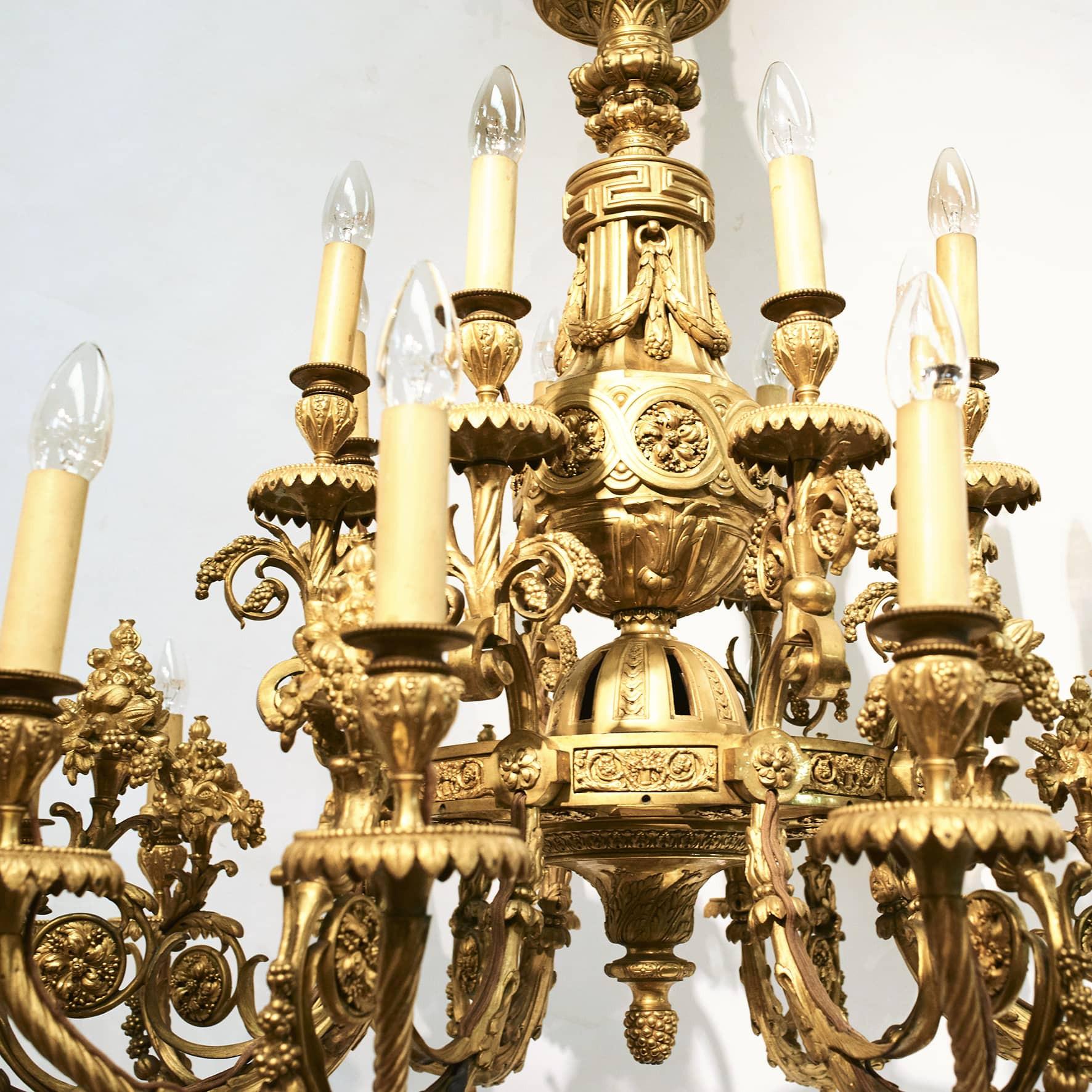 Rare large gilded twenty four light bronze chandelier in Louis XVI style, approx. 1860. Spectacular in size and quality.
The two tiered body is finely casted overall with ornaments of leaves and clusters of grapes.
Crown decorated with ram