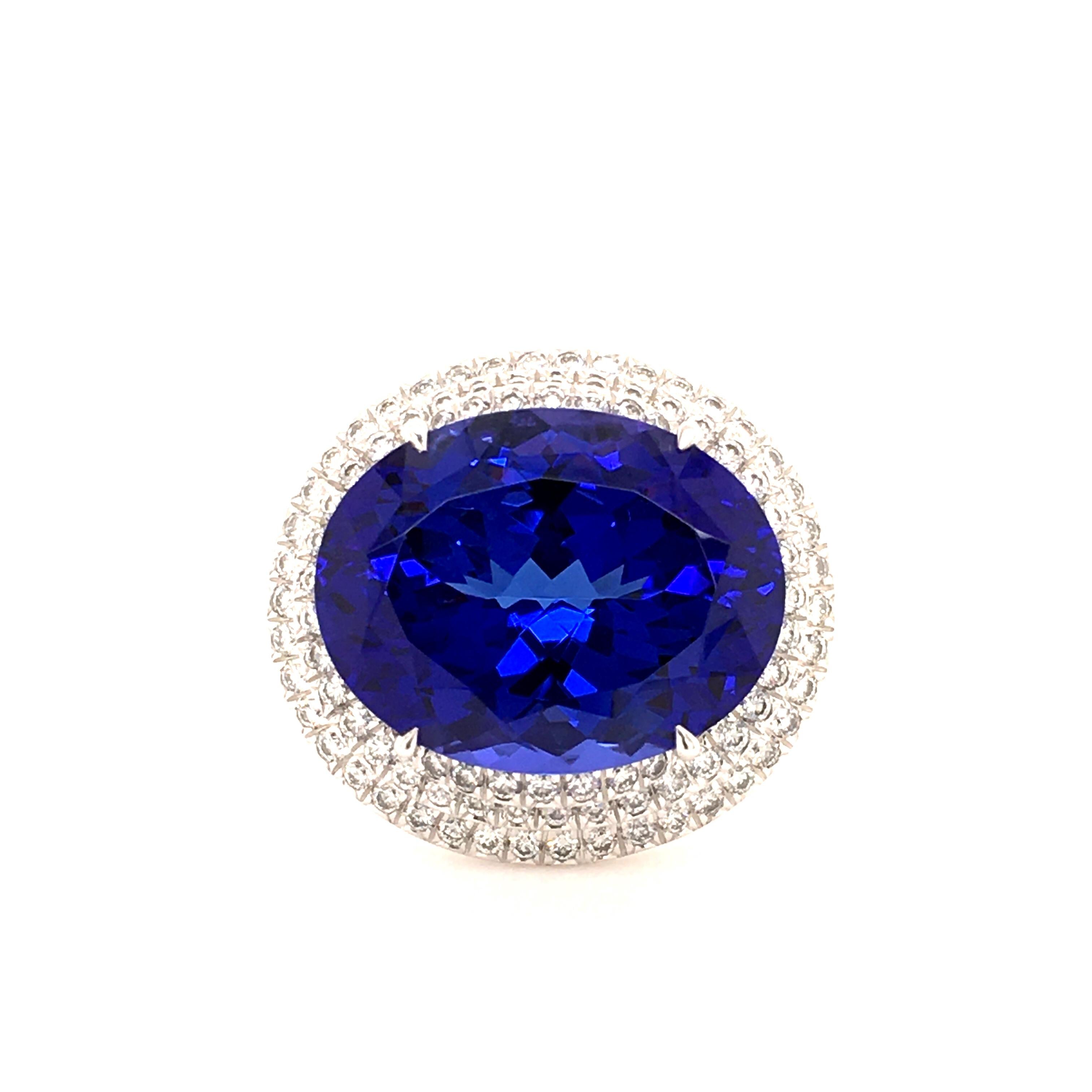 Very fine oval tanzanite of 23.39 ct set in a Gubelin ring in 18 karat white gold. Double entourage set with 134 high quality diamonds (F/G-vs) totalling 1.94 ct. The Swiss, family-owned House of Gübelin, was founded in 1854 and is known for its