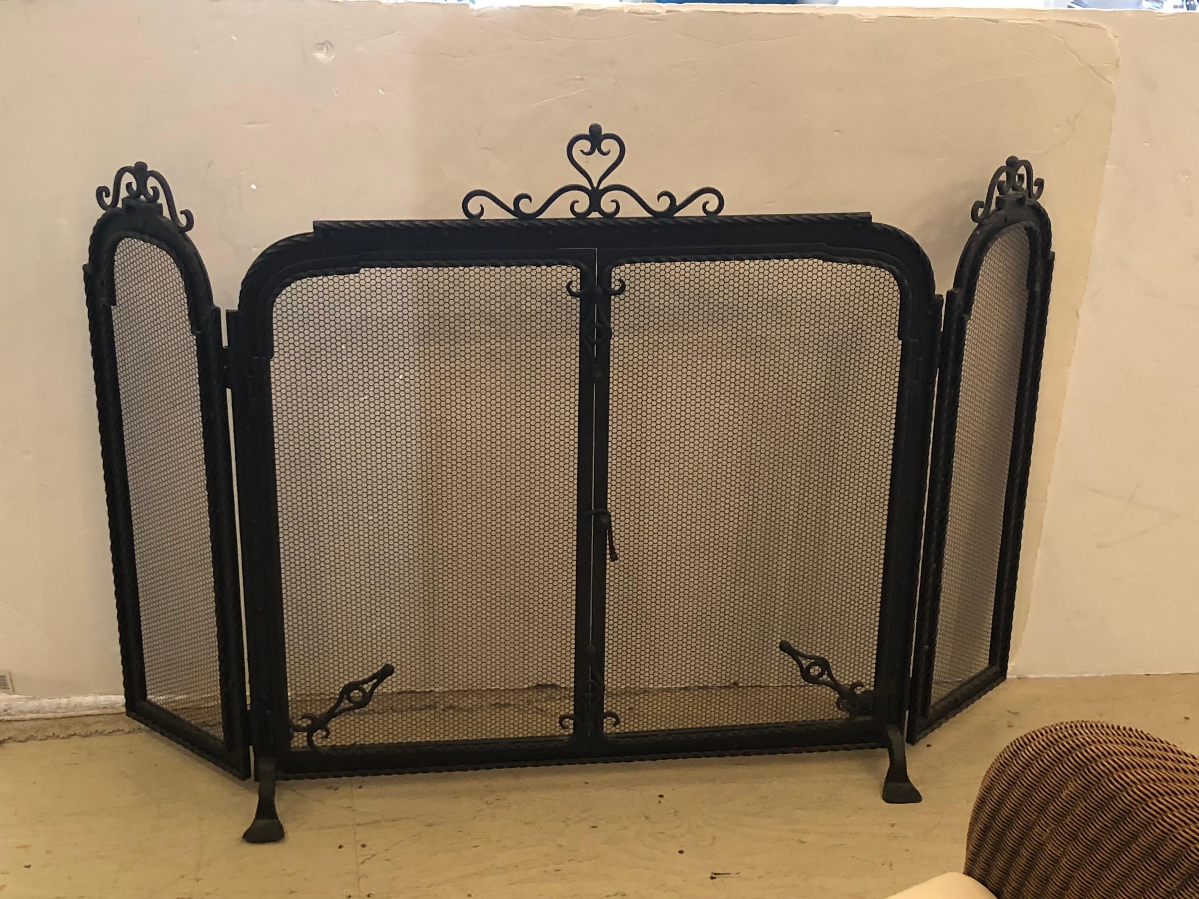 1940's spectacular heavy mesh screen and black wrought iron  3 piece fireplace screen with doors that open in the center section.
Center is 34