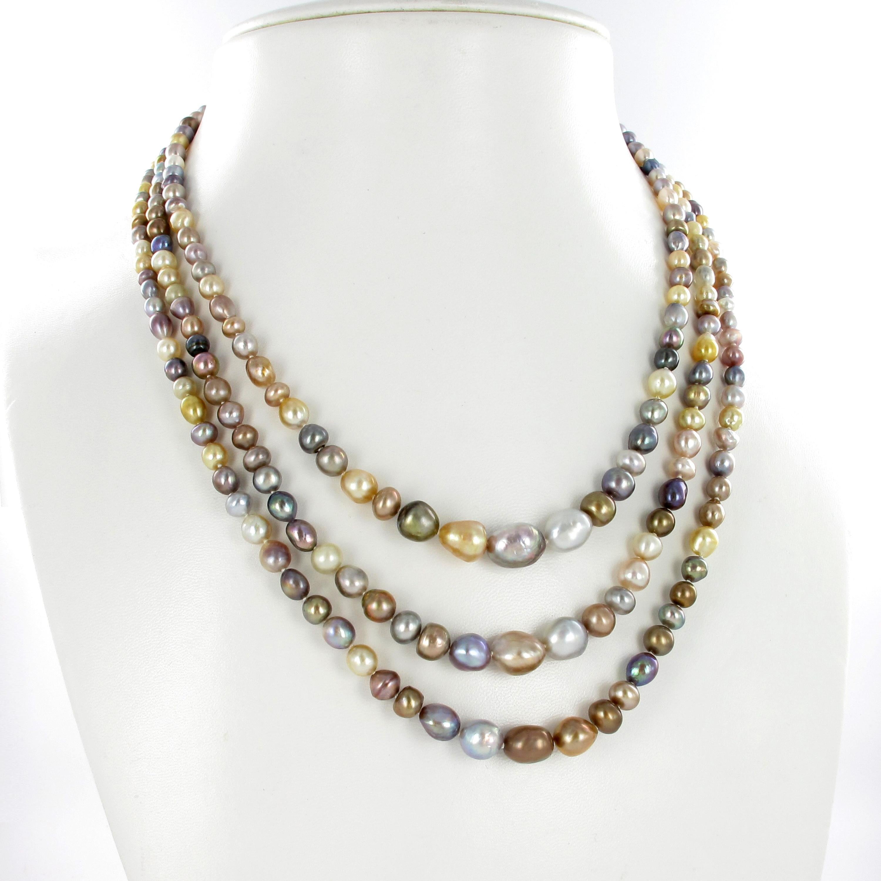 This marvelous 3-strand necklace consists of 258 multicolored natural pearls of various shapes and sizes. Softly graduated and elegantly spaced rows. 
The antique clasp in 18 karat white gold is set with a 1.20 carats Old European cut diamond of K