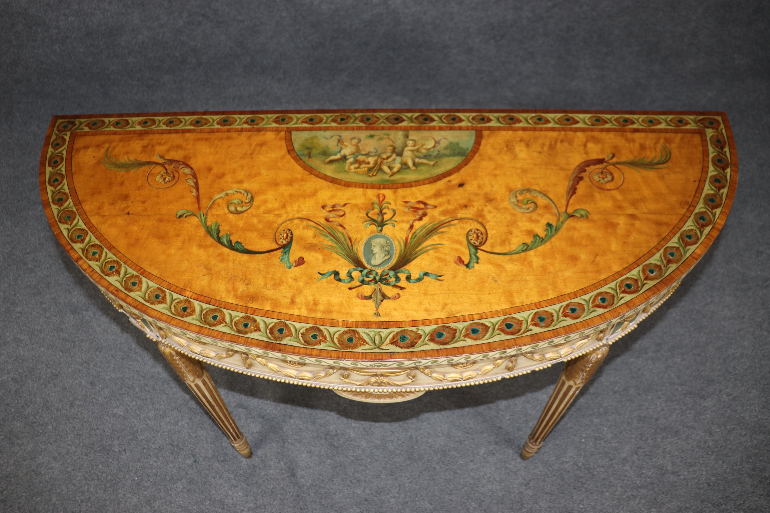 This is a superb, absolutely stunning painted Adams console table. The table features some of the best paint decorated scenery one can possibly find in the market. The cherubs are masterfully painted and absolutely epic. The table is English and