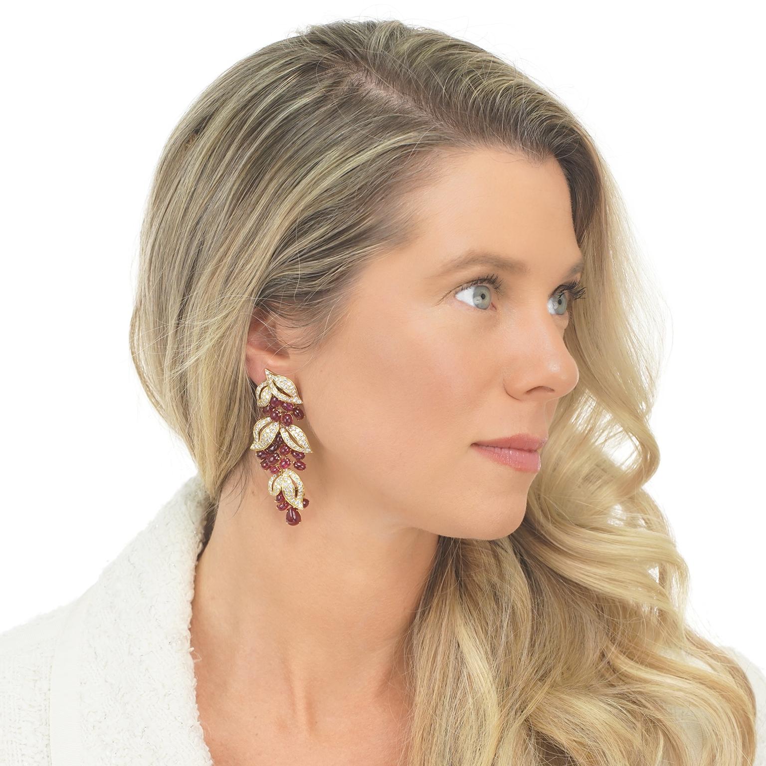 Circa 1970s, 18k, by Adler, Geneva, Switzerland.  These breathtaking earrings by Adler of Geneva feature an elegant organic landscape festooned with rubies and diamonds. Lush berries hang from glittering diamond-set gold leaves in this dazzlingly