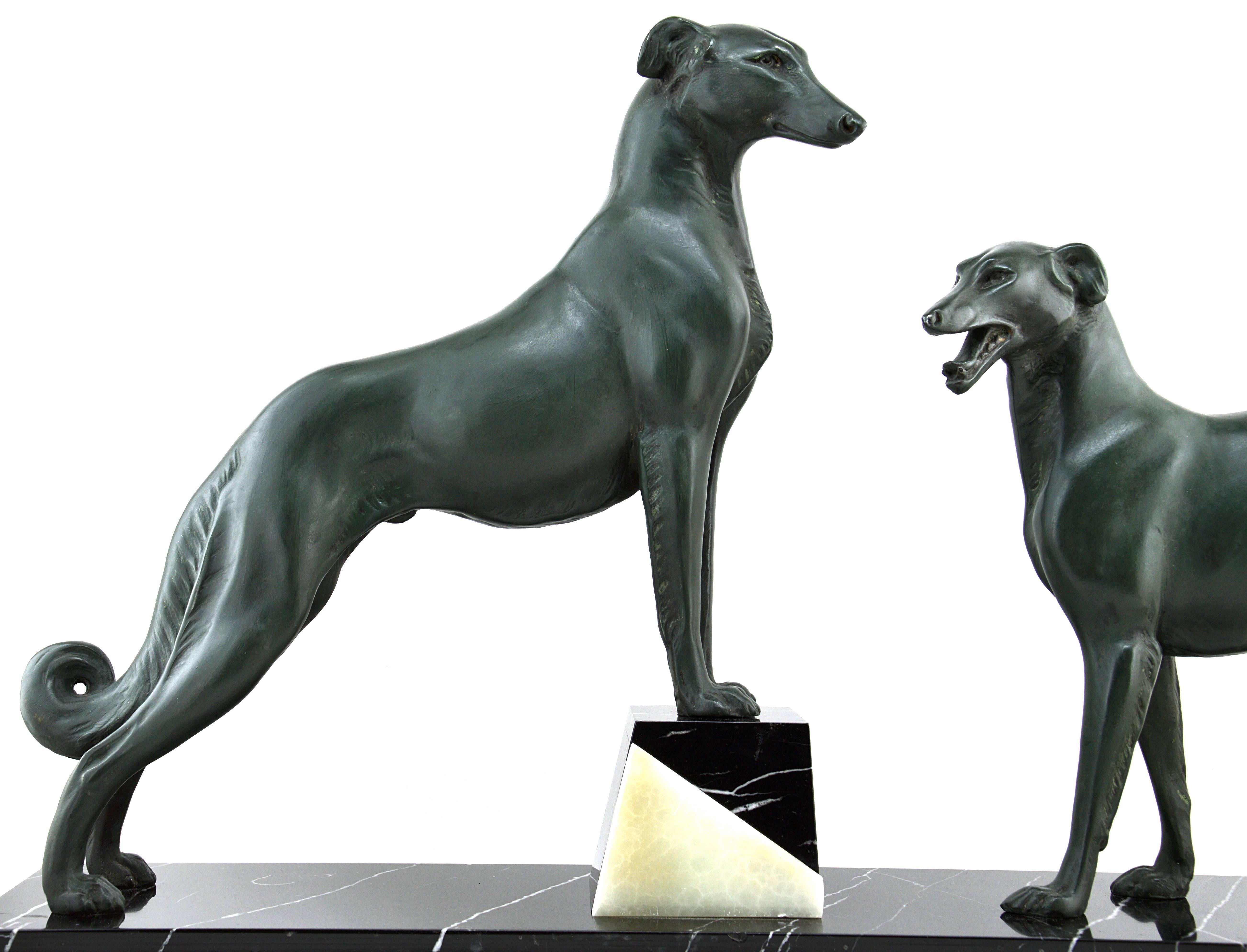 Couple of greyhounds. This sculpture made of spelter, marble and onyx has been made during the French Art Deco period circa 1930. The slender design associated with the noble pose and the size of the greyhounds gives a spectacular and immediately