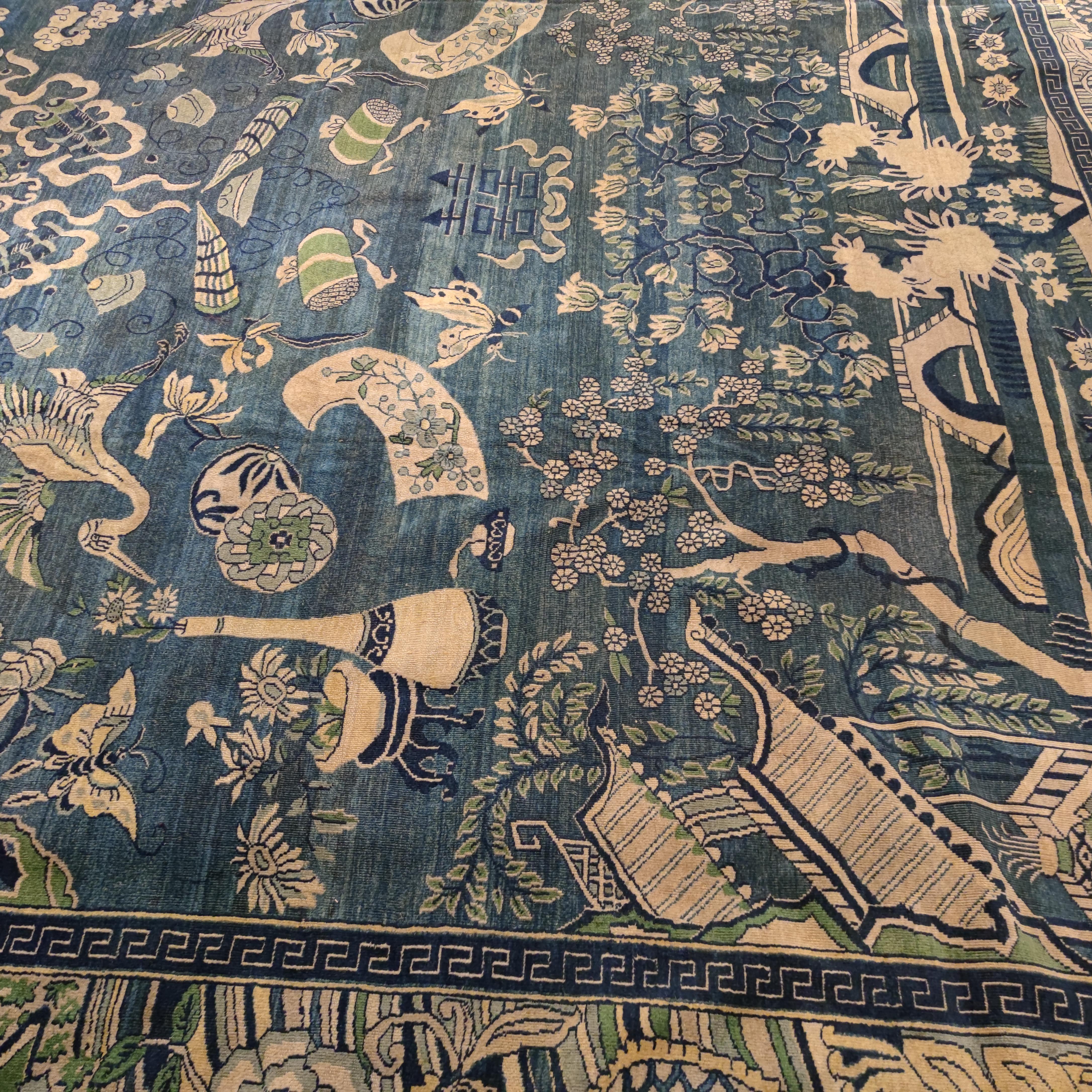 A specific cluster of northern Indian rugs are inspired by antique Chinese weavings, and are often referred to as Indochine. Here the light blue background hosts a very rich flora and fauna, punctuated by Chinese symbols of longevity. A truly