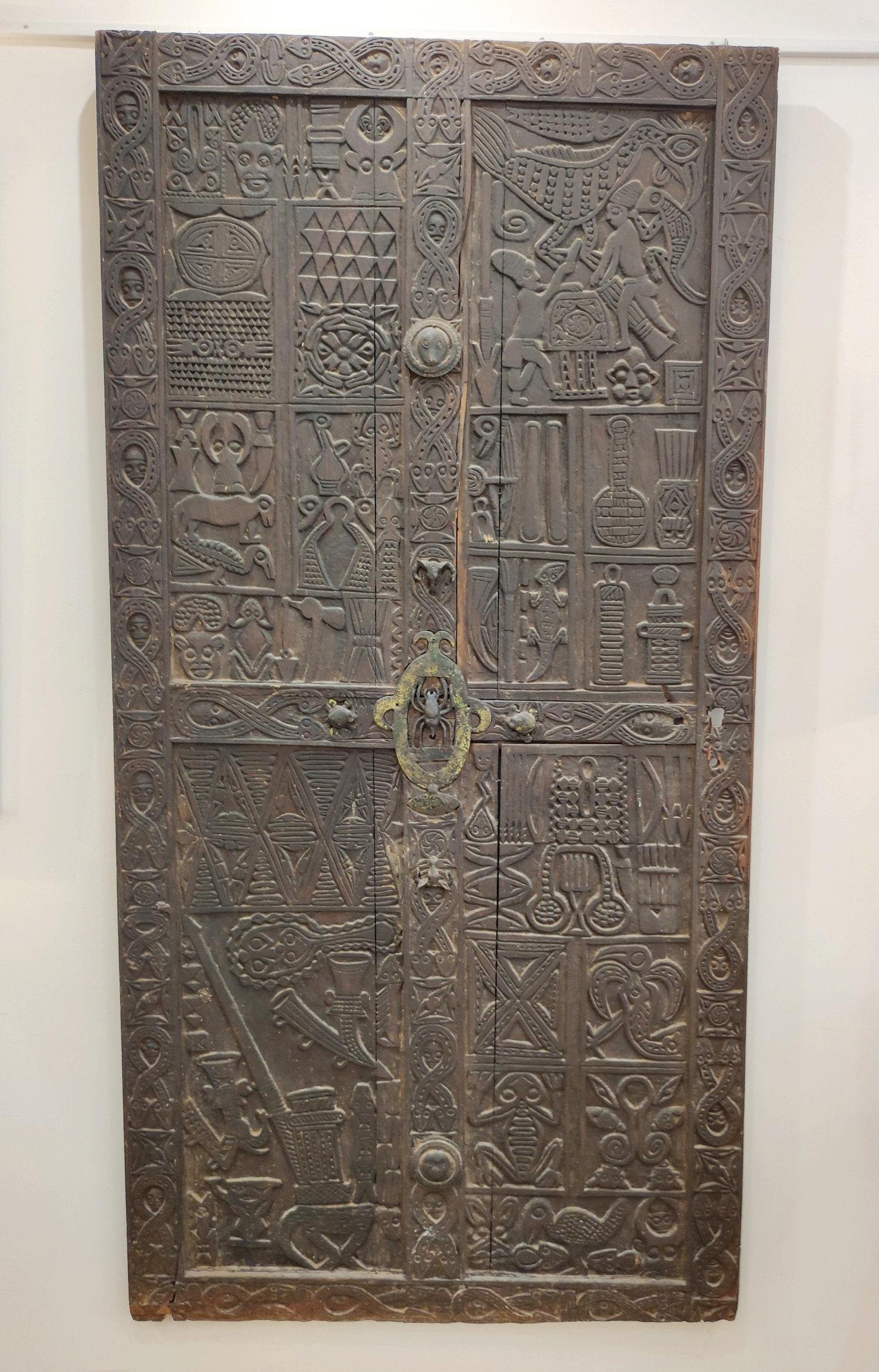 Spectacular Bamoun ( Cameroon)door end of XIX°century from Sultan NJOYA Palace.
It would be the door to the sultan's bedroom.
Very fine sculpting  work with Royal attributes like the snakes, and metal inserts.