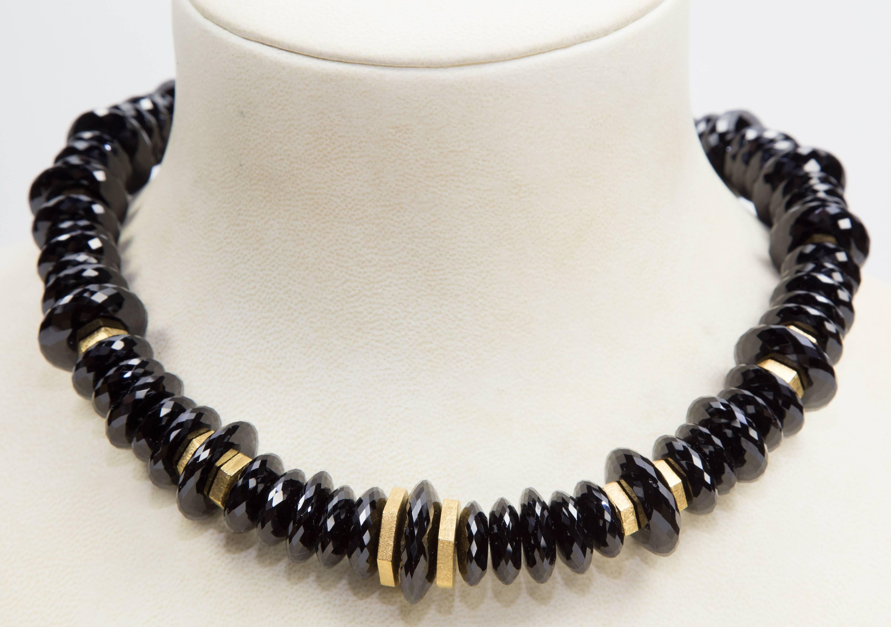 Shimmering High Quality facet cut Black Spinel rondelle beads interspersed with Gold plated Sterling Silver discs and a unique Gilded Sterling Silver clasp give this simple Stunning necklace Dramatic Flair. Spectacular in its simplicity! A perfect