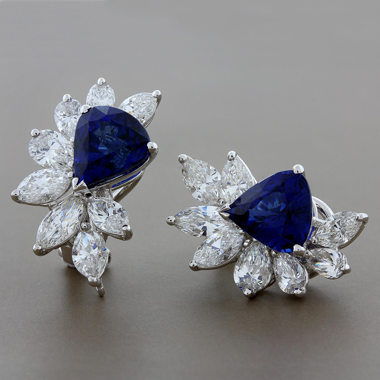 These earrings are breathtaking in quality and craftsmanship. 7.42 carats of fine deep ocean blue trillion cut sapphires are featured in these earrings. A unique half cluster of 5.08 carats of colorless VS quality marquise and pear cut diamonds