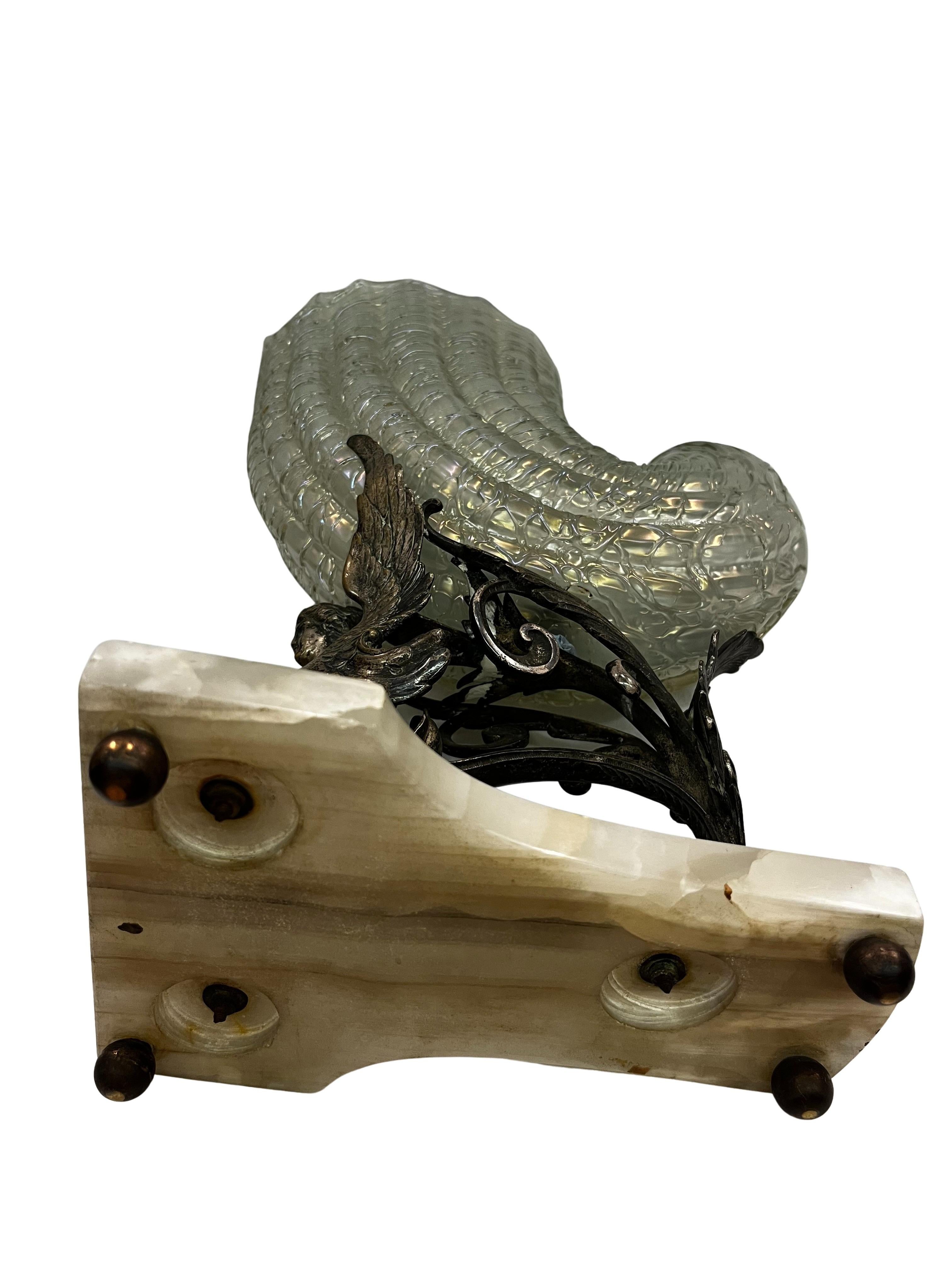 Outstanding Art Nouveau object, a bronze spinx on an onyx base on spheres, supporting a cornucopia, made by the Kralik glass manufactory, around 1900, Vienna, Austria.

This special object impresses with its outstanding quality, size, and condition.