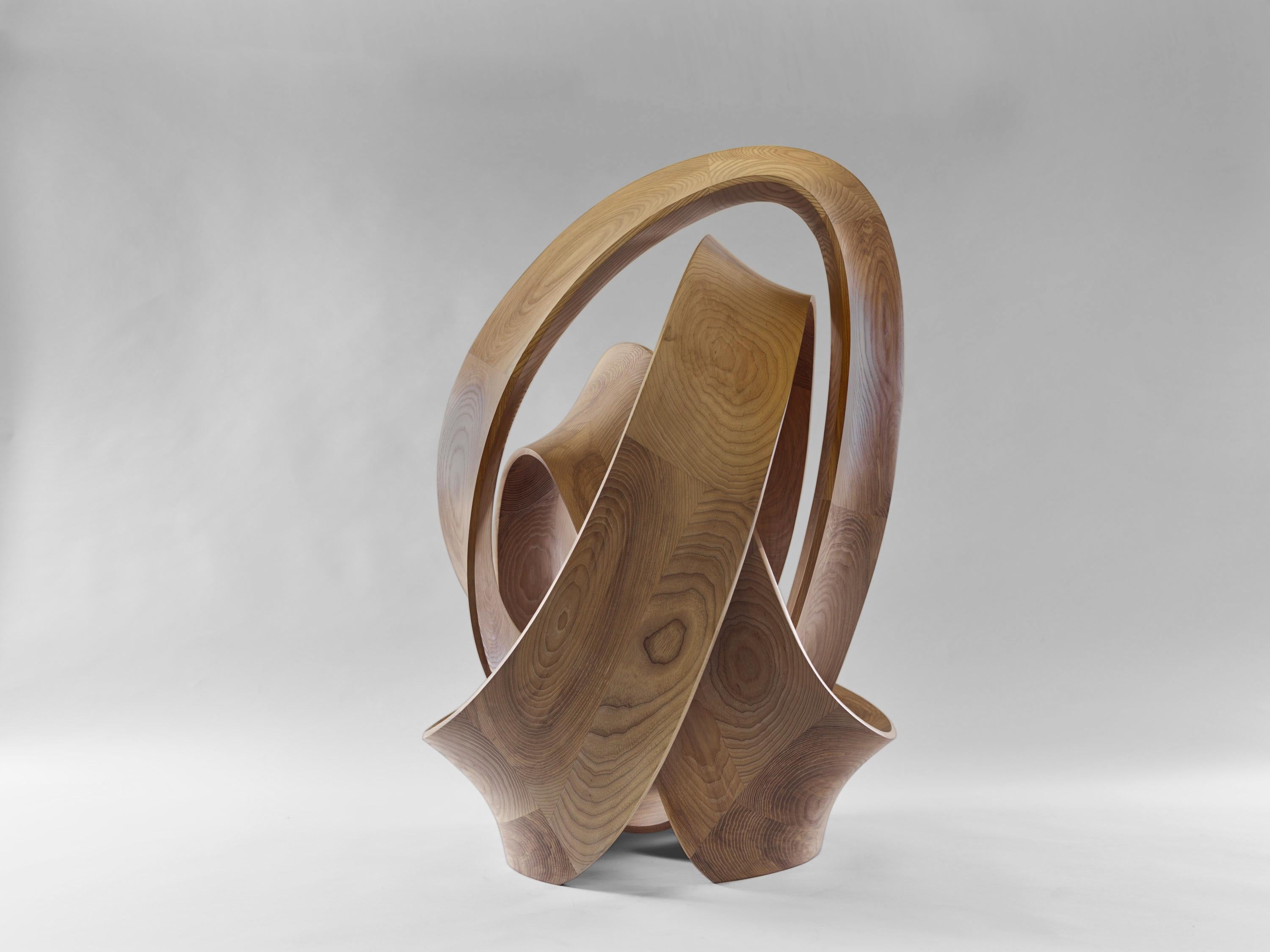 The 'Knot sculpture' by British designer-maker, Tom Vaughan, is hand-carved from natural or ebonized ash. Standing just over a metre high, It is part of a series of work tracing three-dimensional paths of movement through a solid, functional form,