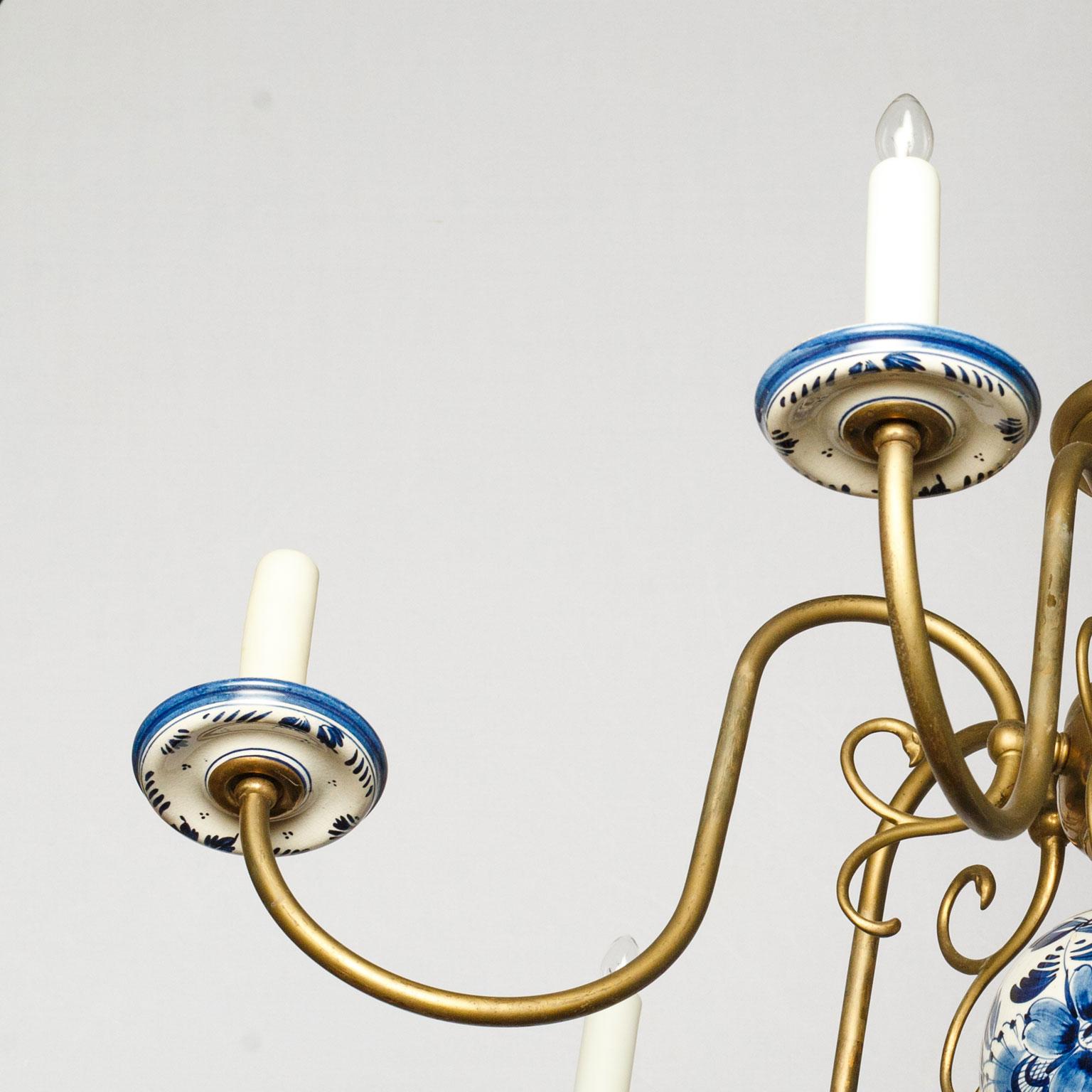 Spectacular delft and bronze chandelier from the Netherlands, circa 1940s. Beautiful and one-of-a-kind Dutch style chandelier in cast bronze. Finished with hand painted (blue on white) lower orb and bobeche cups. The patina on this light is