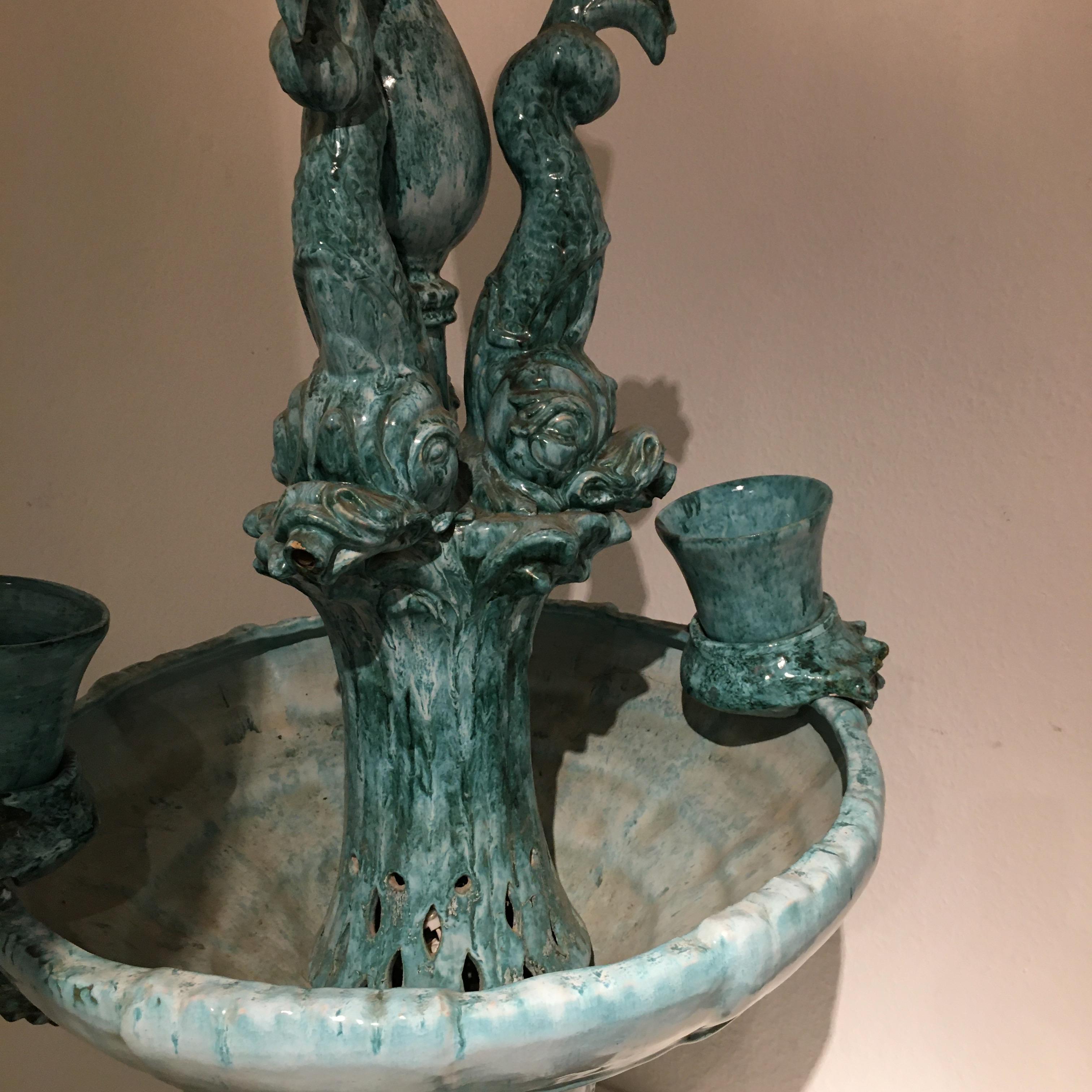 Large ceramic enlightening fountain from Vallauris France.
The foot base, basin, dolphins and the lanterna on top comes in 4 separates pieces.
Water comes out of the mouth of the dolphins in a close circuit.
Vallauris, France, circa 1950.