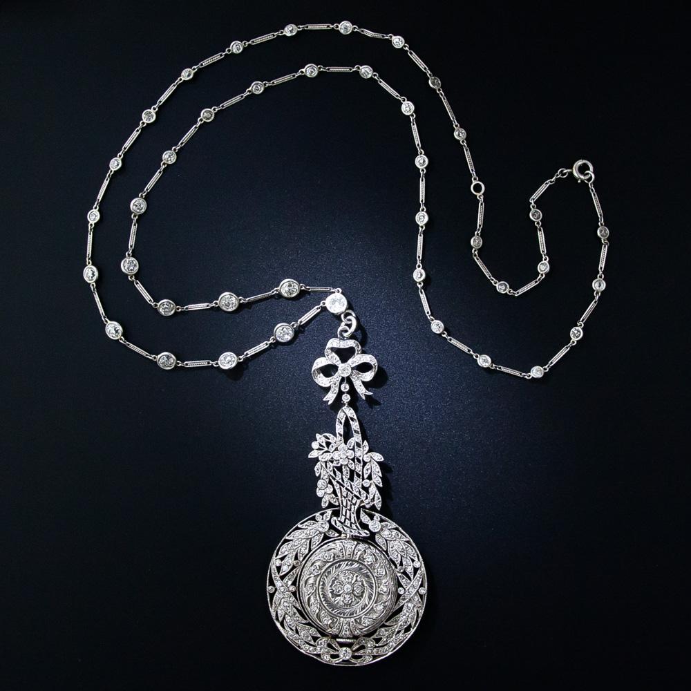 This truly extraordinary necklace is one of the finest examples of Edwardian jewelry artistry we've seen in a while. A diminutive, and beautifully decorated platinum and diamond ladies pendant watch is magnificently framed, and swings freely, inside