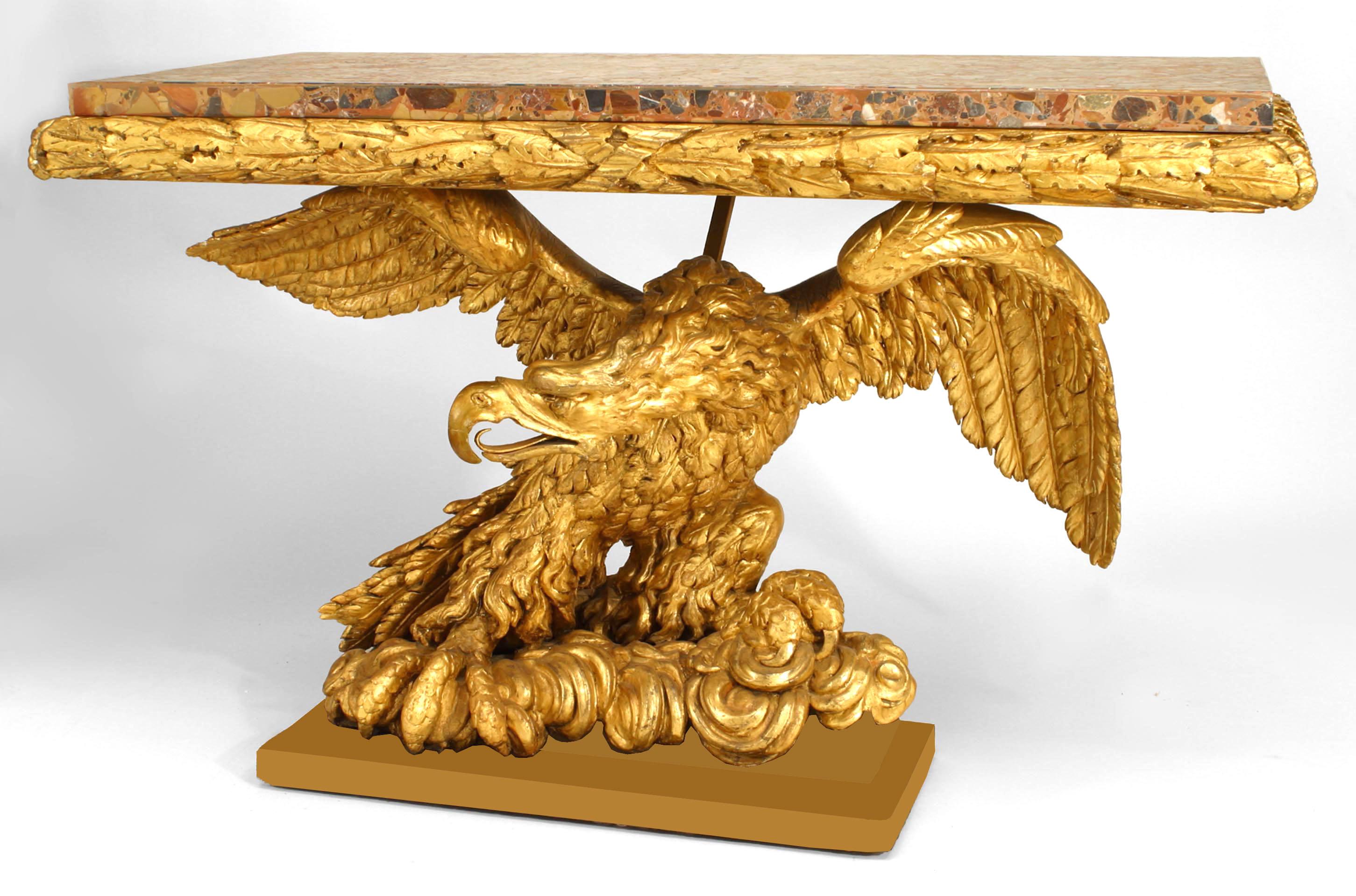 Italian Empire late 18th Century / early 19th Century console table with a variegated marble slab and gilt caved acanthus leaves wooden top supported on a gilt carved base depicting an eagle with outspread wings seated on an ebonized platform.
