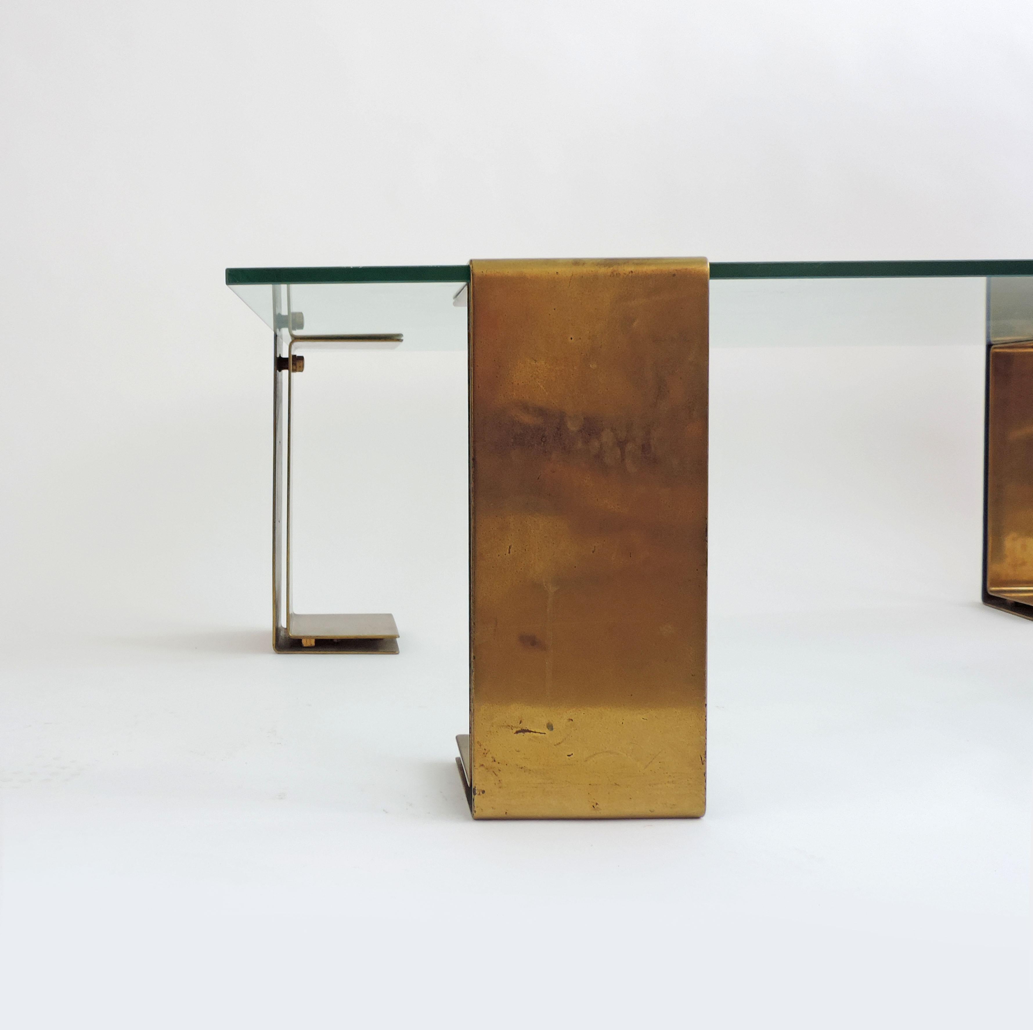 Spectacular Italian 1970s coffee table.
Four heavy brass feet which can be placed in different positions.