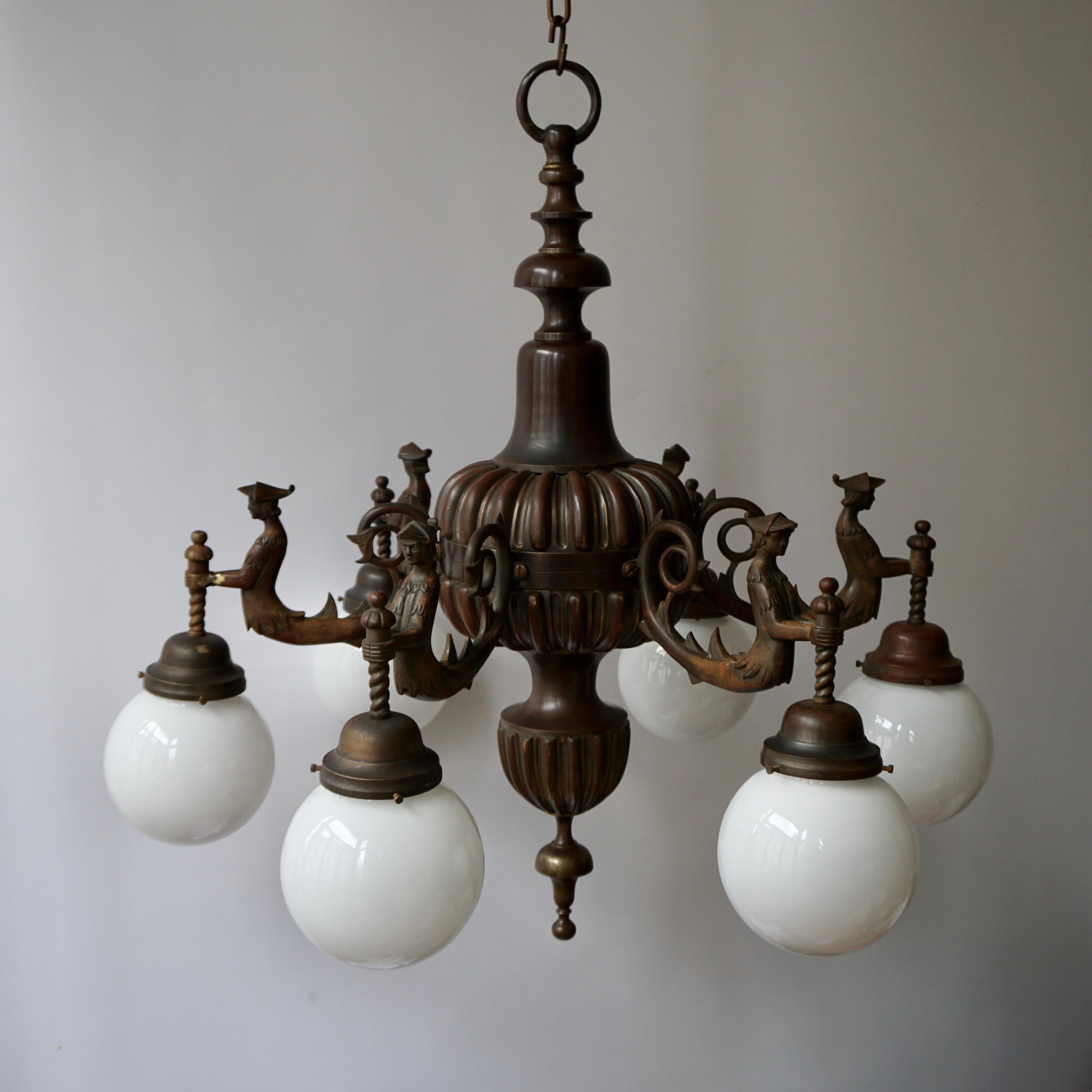 A spectacular and large Italian patinated bronze multi light figural chandelier.
Measures: Diameter 78 cm.
Height fixture 80 cm.
Total height including the chain and canopy 150 cm.
Weight 20 kg.

Not wired for US standard.