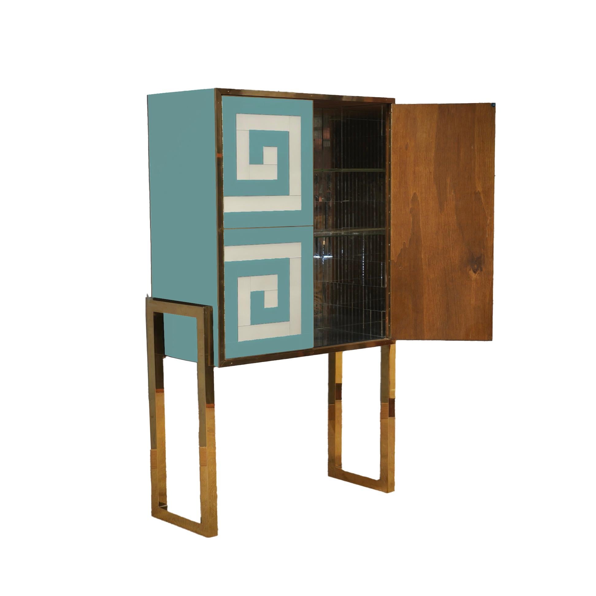 Discover the charm of Italian craftsmanship with this Spectacular Light Blue & White Bar Cabinet, a masterpiece of design and functionality. 

Handcrafted by skilled artisans, this unique piece combines traditional techniques with a Mid-Century