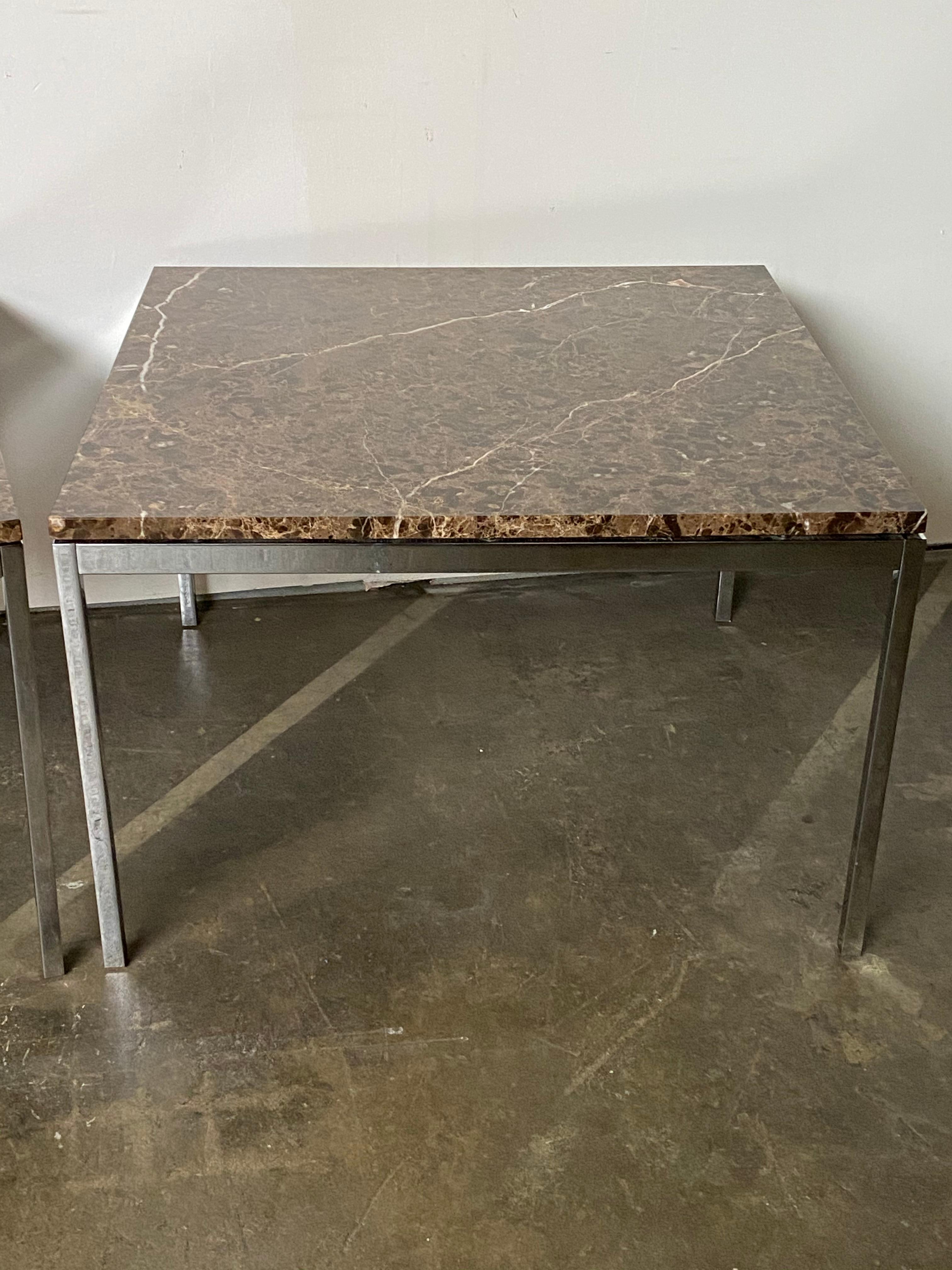 Amazing marble slabs adorn this matched pair of Florence Knoll end tables square cut stone with brilliant color and vein details atop chrome square tube frames. In very good condition with minimal signs of use. Stamped Knoll and guaranteed