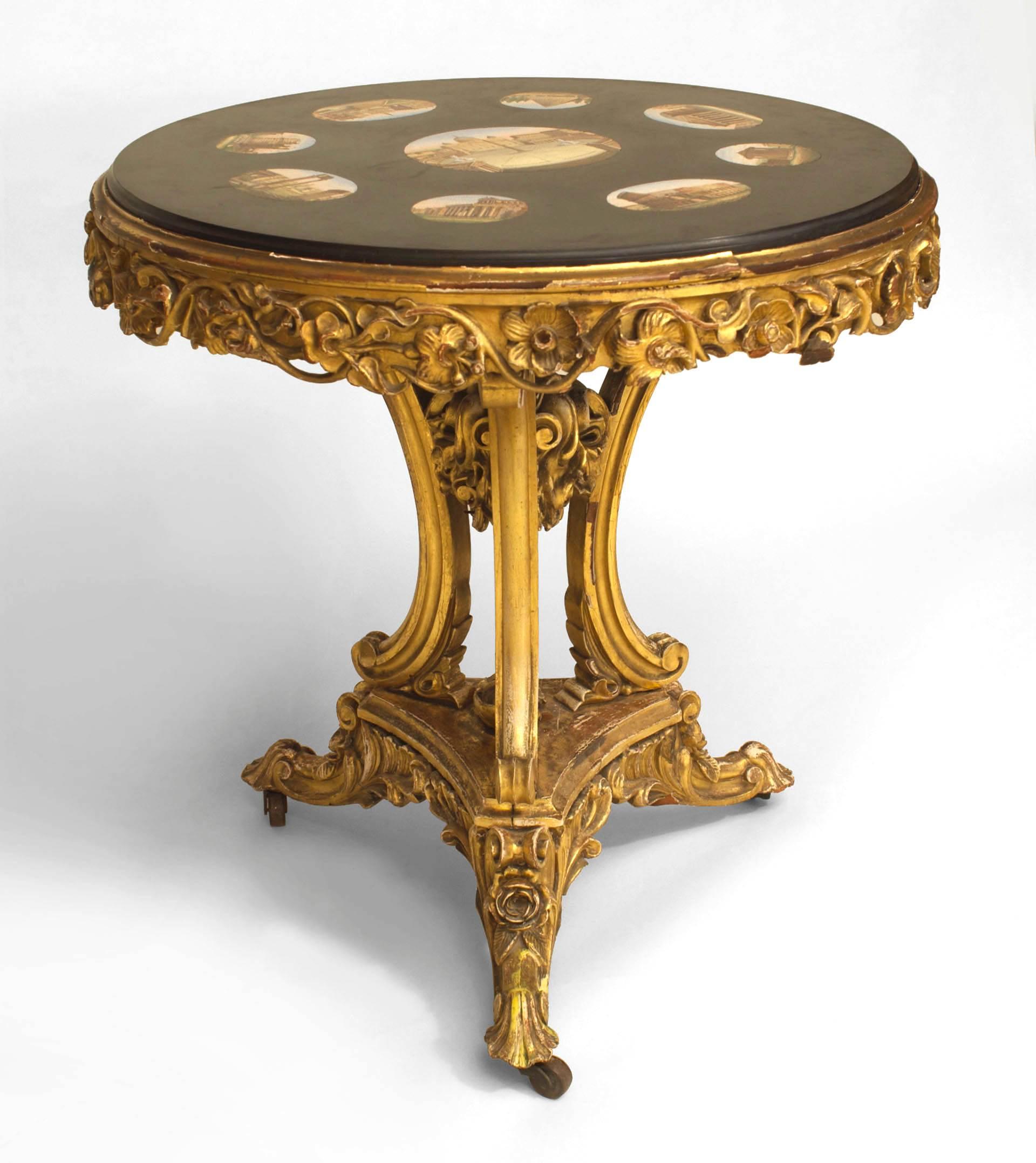 Italian Neoclassic (19th Century) gilt wood carved floral base end table with a round inset black marble top having pietra durra inlaid scenes of classical Roman building.
