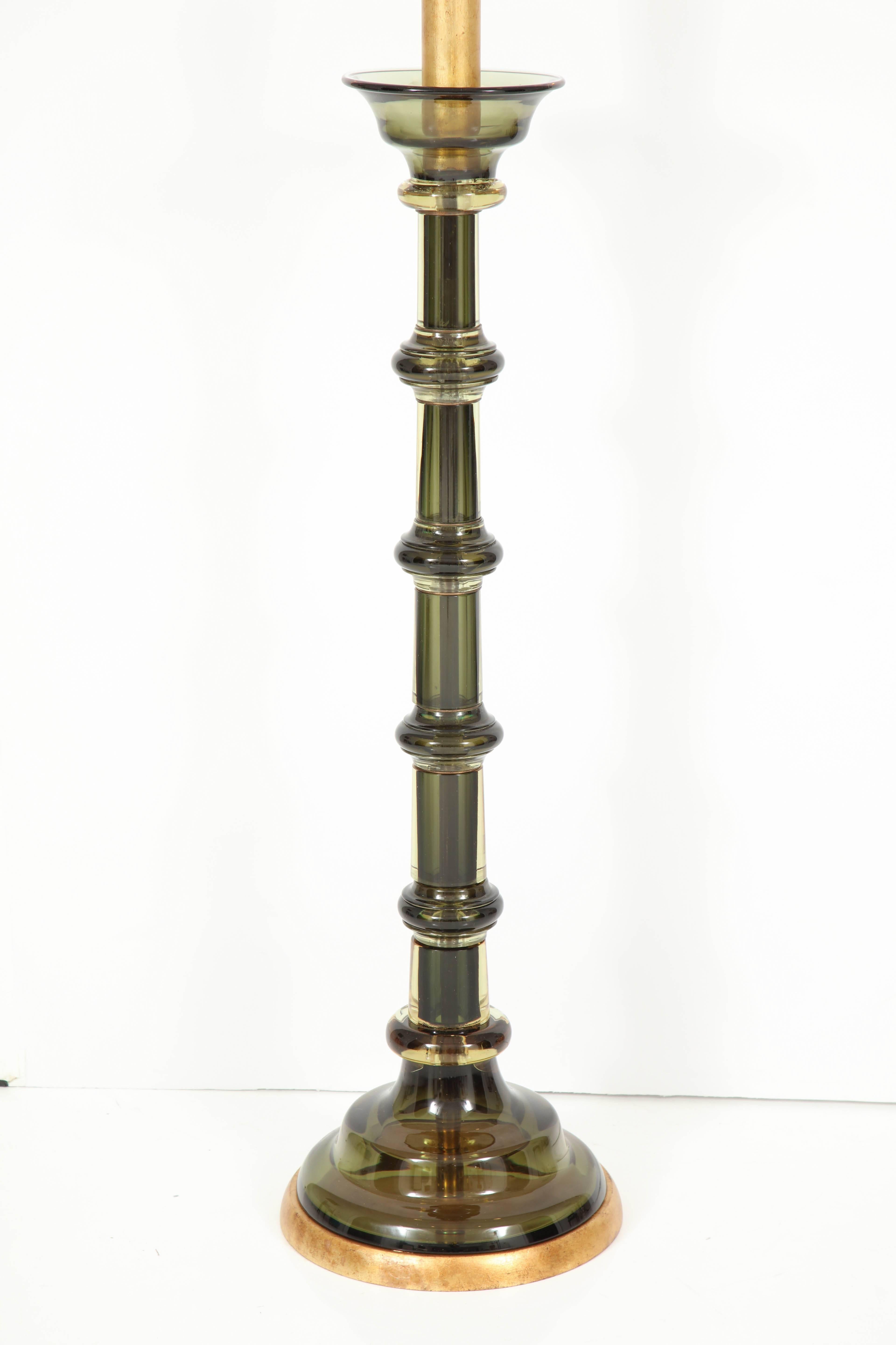 Spectacular floor lamp by Seguso.
The forest green Murano glass lamp body is mounted on a gold leaf base and has been newly rewired for the US with a polished brass double cluster.
