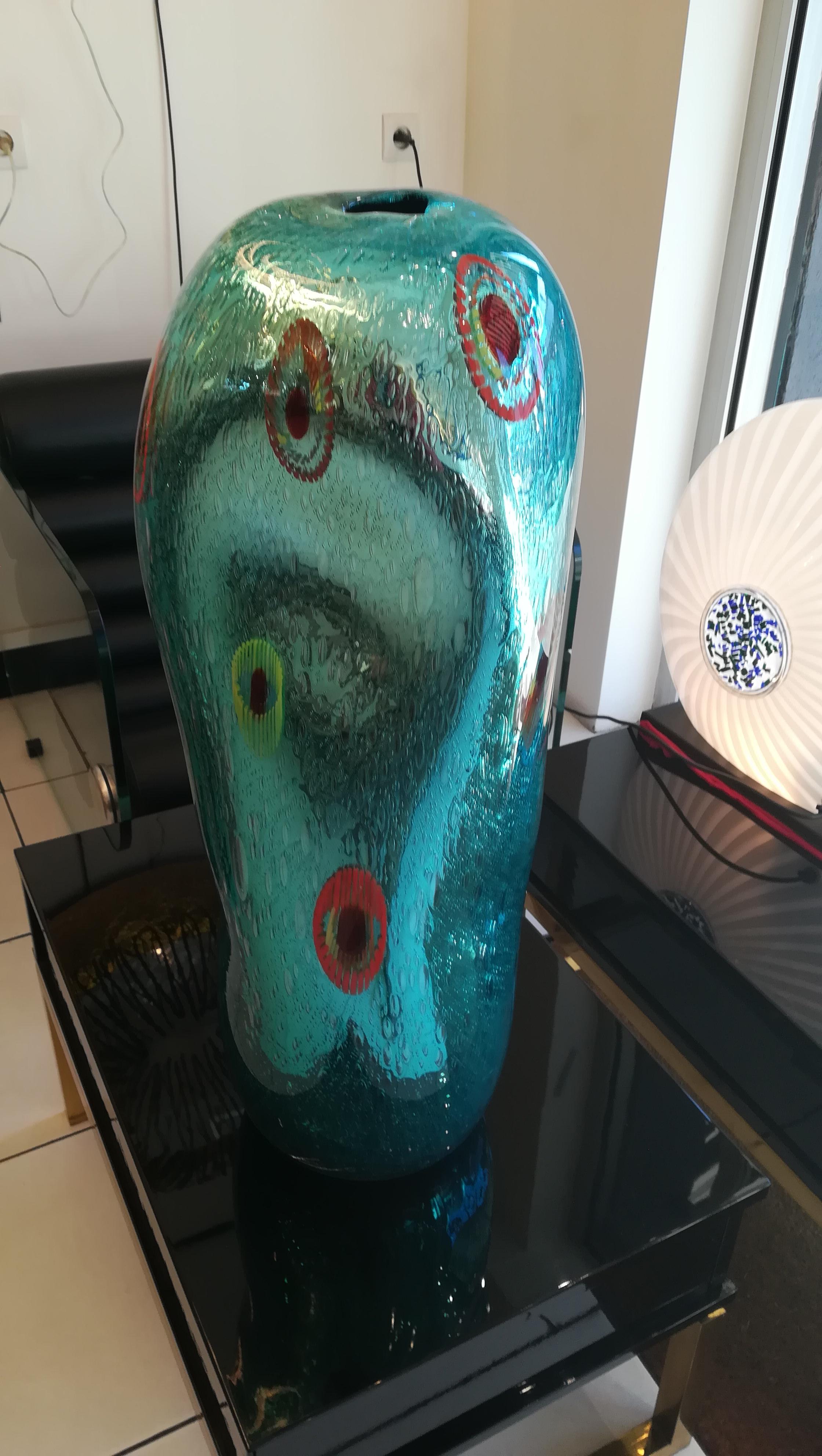 The vase is signed, one-off, in perfect condition, blue Murano glass, free-form, with red murrines inclusions.