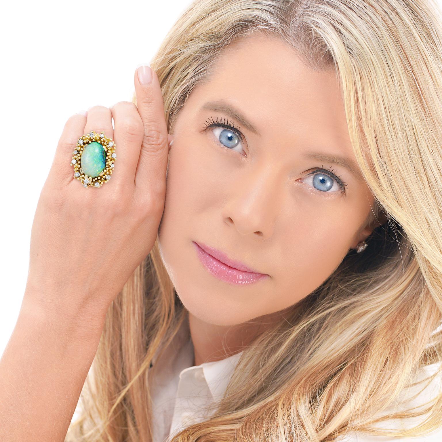 Circa 1960s, 18k, Germany. This compelling sixties ring features a 16.27-carat natural opal set in heavy organo-chic gold work. Displaying green, blue, purple, and orange hues, this stone has a mythical vibe. The visual story is oceanic, or perhaps