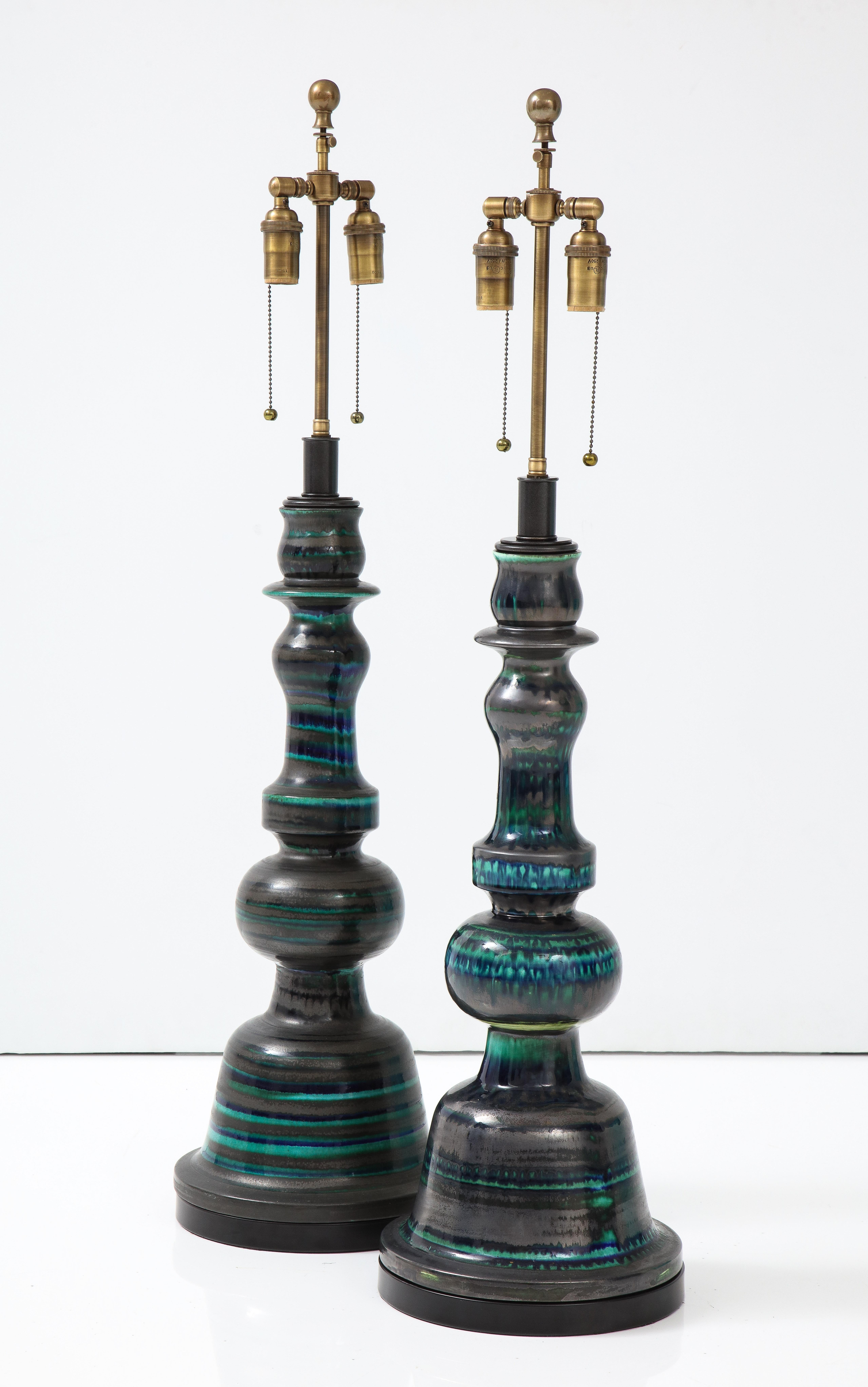 Stunning Pair of large ceramic lamps.
The Totem shaped lamps are slightly different in size as they are handmade.
They have a striped glazed finish and they are Newly rewired with adjustable antique bronze double clusters that take standard size