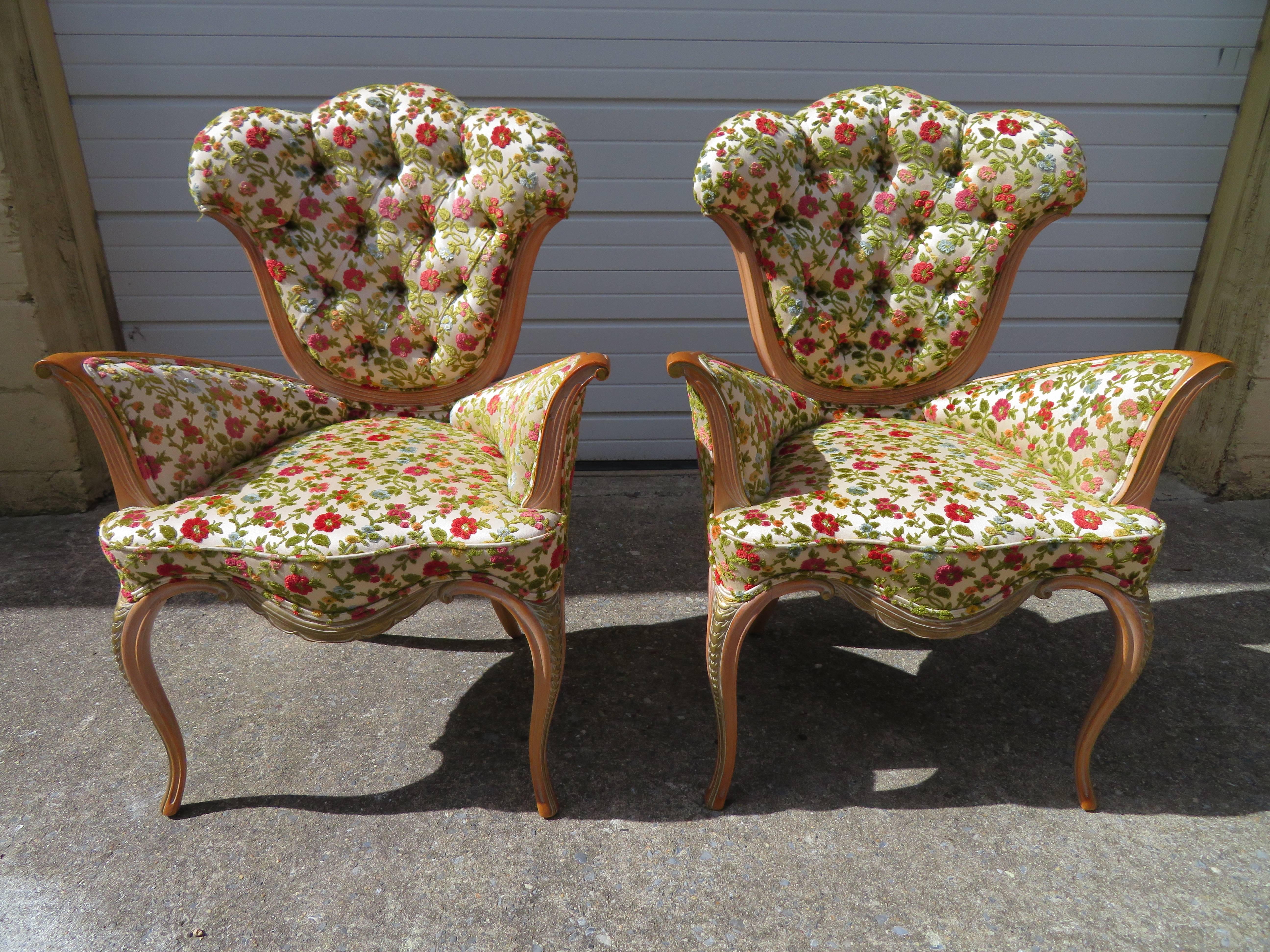 Spectacular pair of Grosfeld House winged armchairs. This pair is in excellent vintage condition retaining their original textured fabric. We love the original floral cut velvet fabric with the ornately carved wooden legs and arms. This pair is